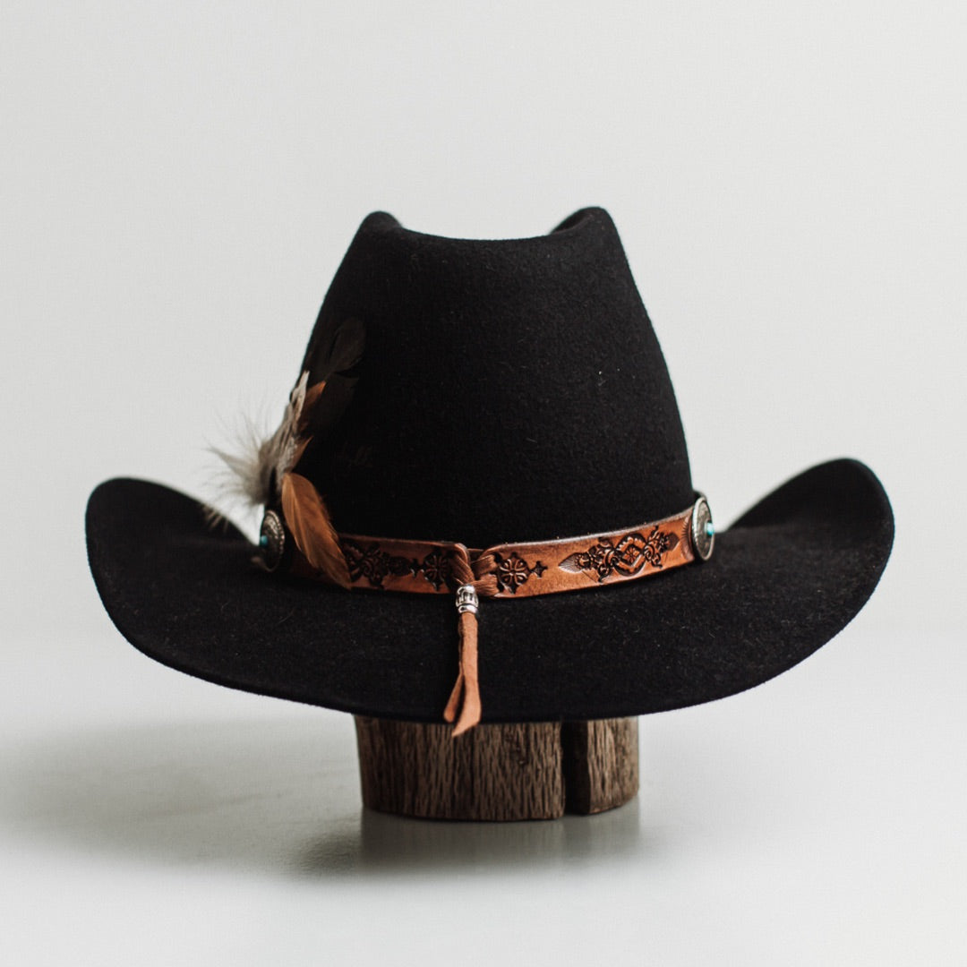 Back view of The PHYLLi dark navy felt hat by PHYLLi Designs featuring burnt branded pattern on the back left crown.