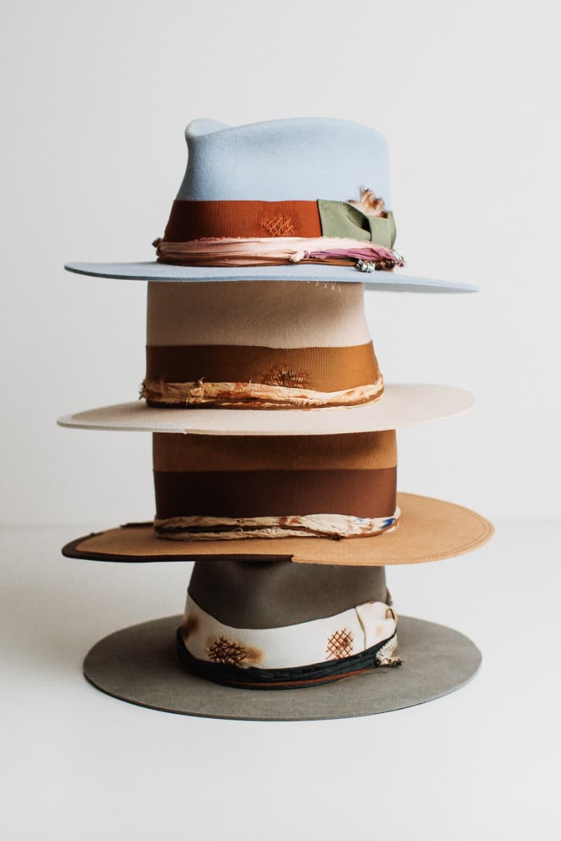 Stack of multicolored hats on a white background