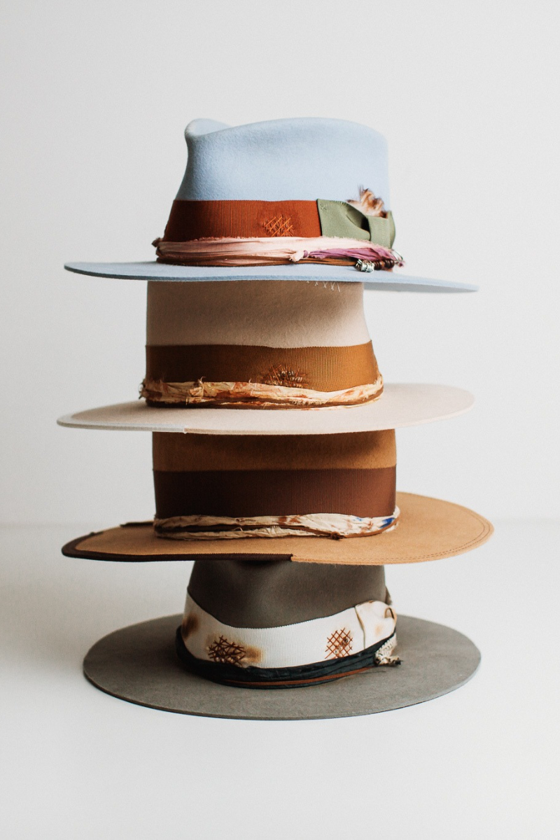 Stack of decorated felt hats in various colours – custom made hat from PHYLLi Designs