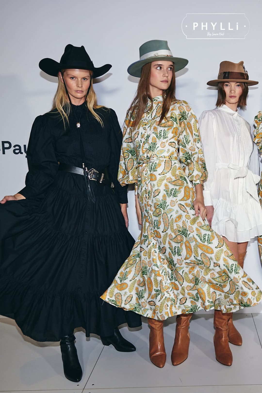 Woman wearing the Accra sage felt hat by PHYLLi Designs with ivory grosgrain ribbon band and twine wrap in fashion show lineup setting.