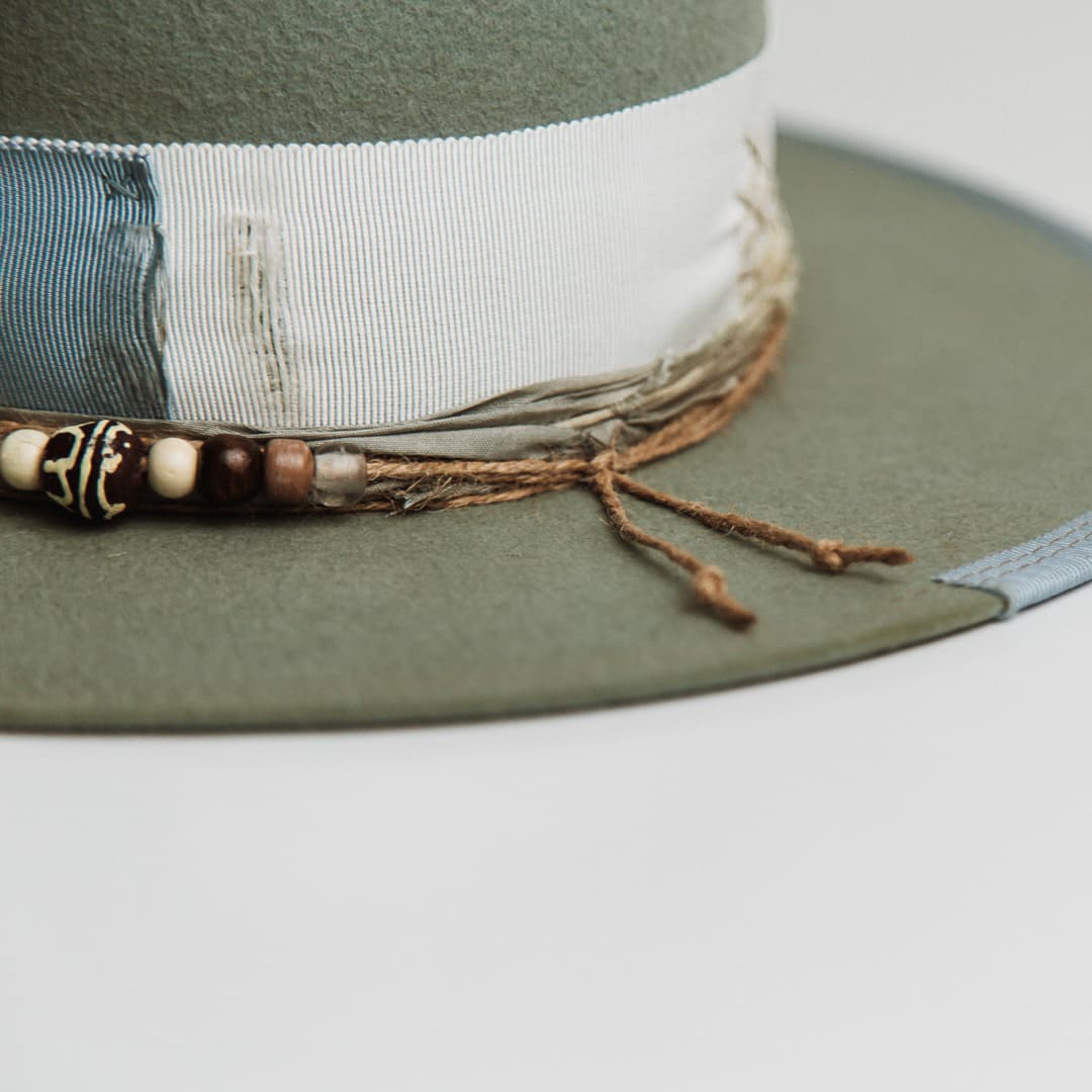 Close up detail of the Accra felt hat showing three twine wrap around the crown.