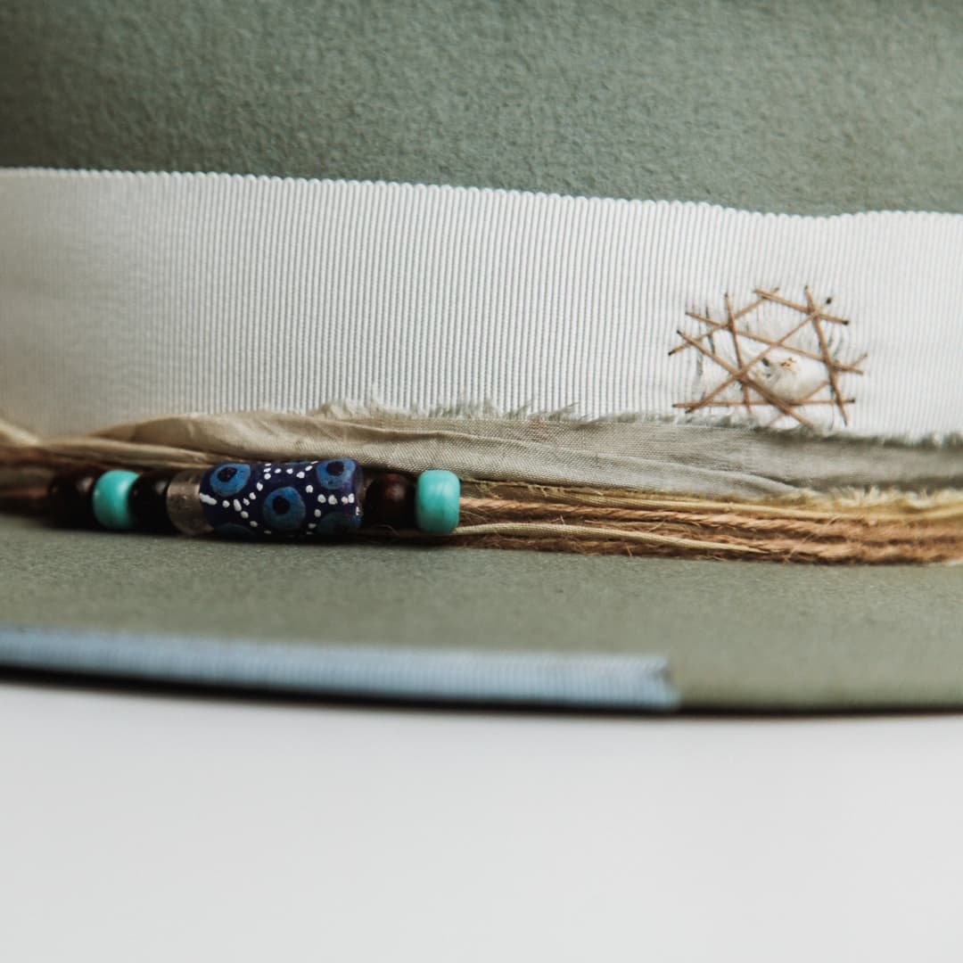 Close up detail of the Accra felt hat showing distressed patches darned in taupe.