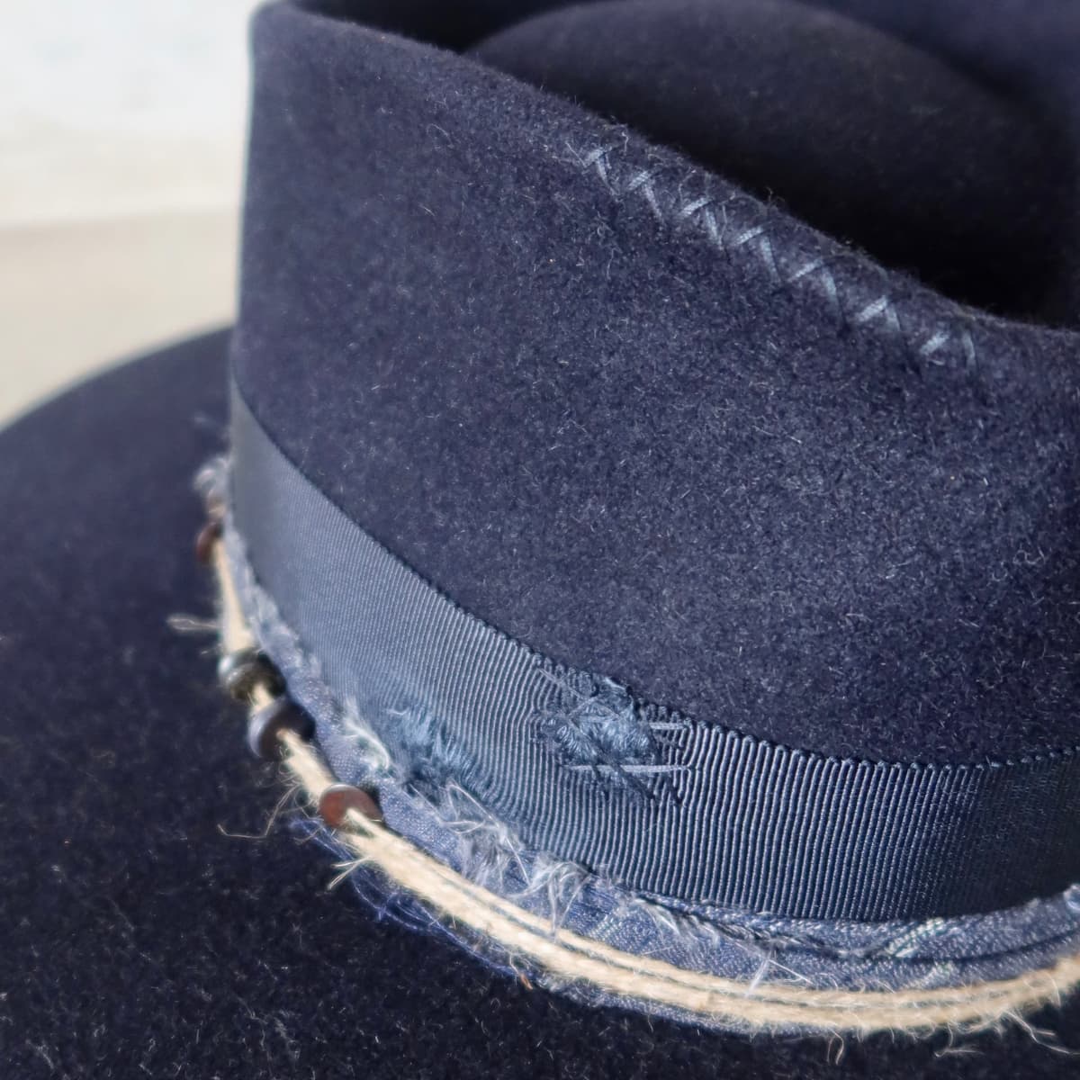 Close up detail of the Armadale felt hat showing hand stitched crosses on the crown.