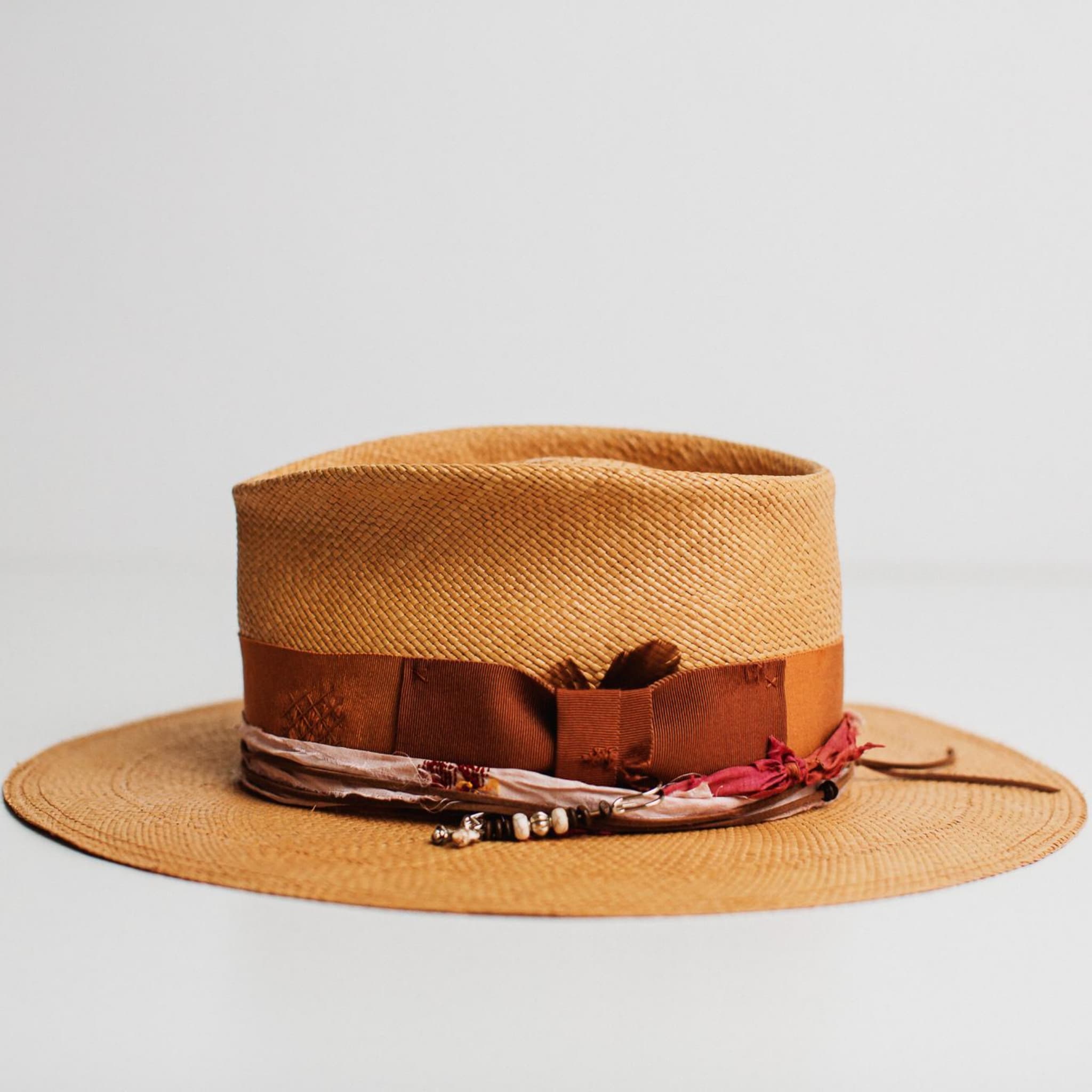 Side view of the Barbados biscuit Panama hat by PHYLLi Designs with copper grosgrain band.