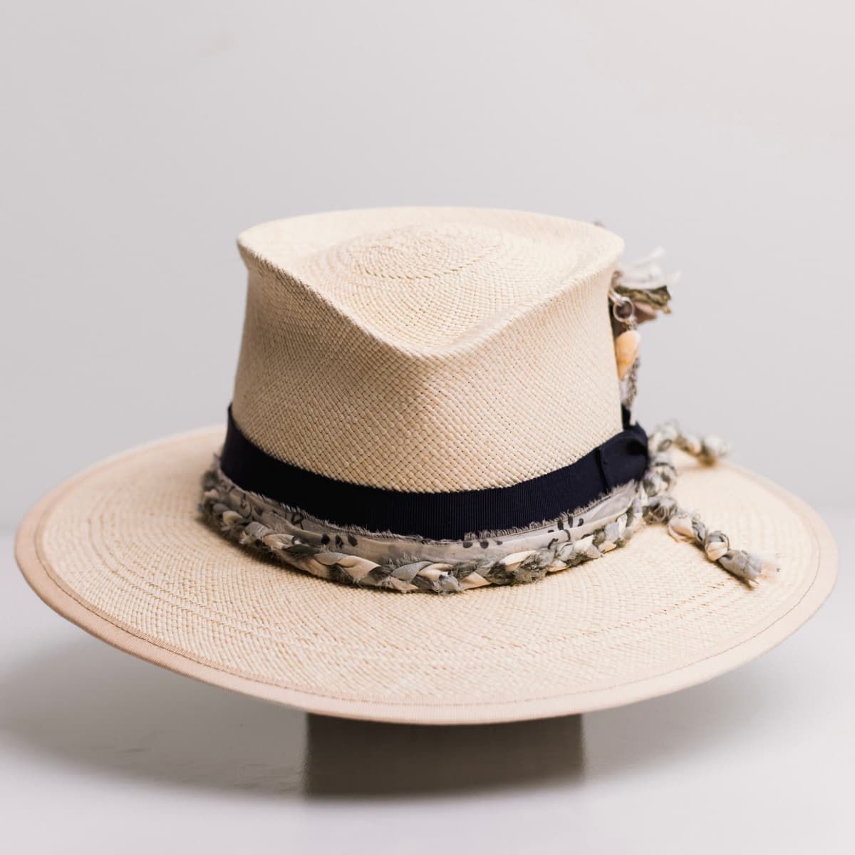 Blue Jean Natural Panama hat by PHYLLi Designs with dark navy Japanese grosgrain bow band, plaited sari silk trim in ivory, olive and teal and silver chunky hat pin.