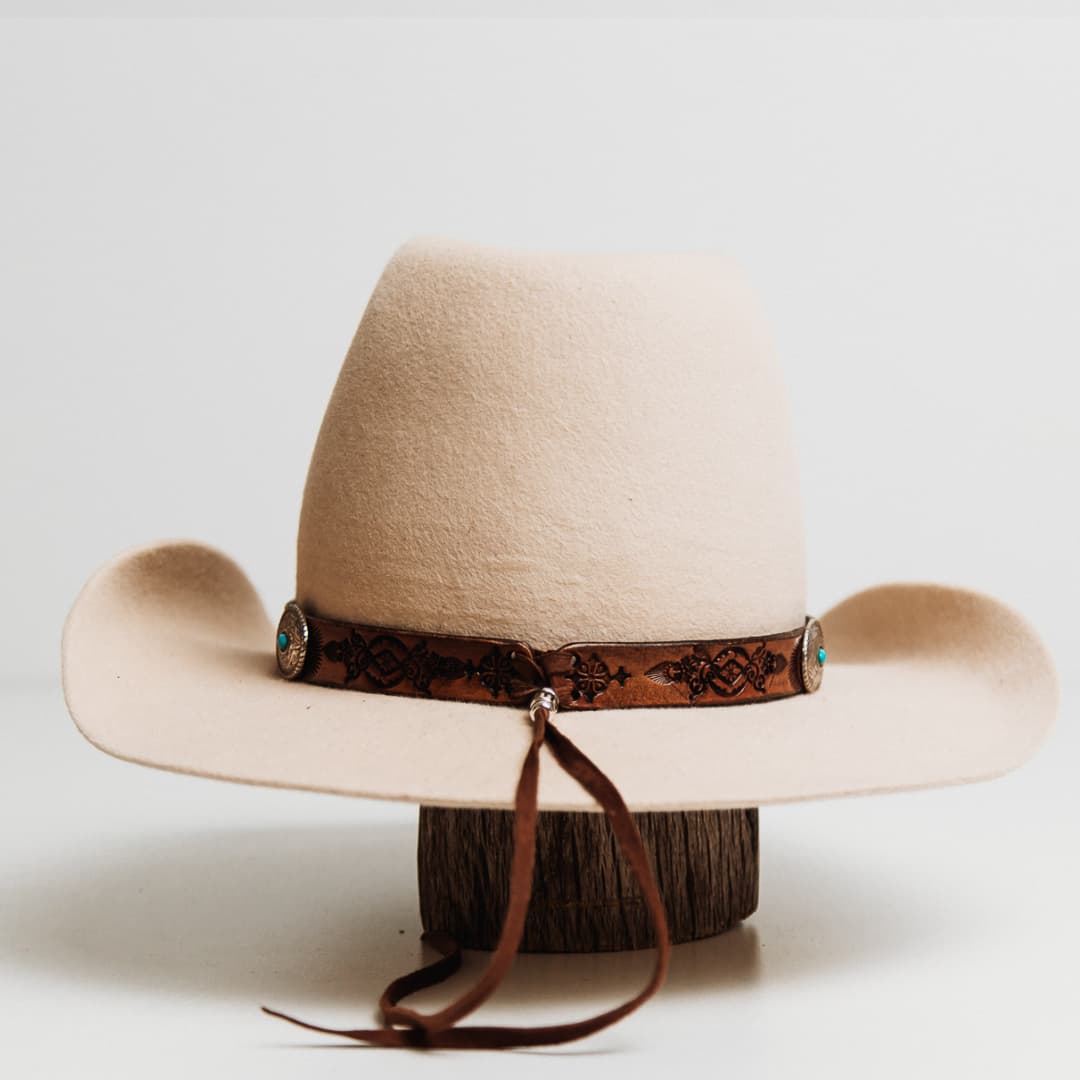 Back view of the PHYLLi x Buffalo Girl Rugged Desert Tie Back Hat Band featuring smoke deer hide lace tie back detail on a beige felt cowboy hat by PHYLLi Designs.