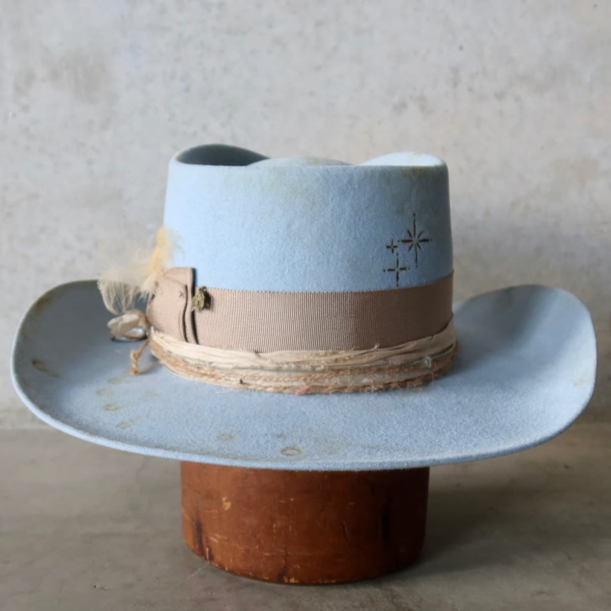 Back view of the Crystal Blue felt cowboy hat Clareville Limited Edition by PHYLLi Designs featuring burnt branded patterns on the crown.
