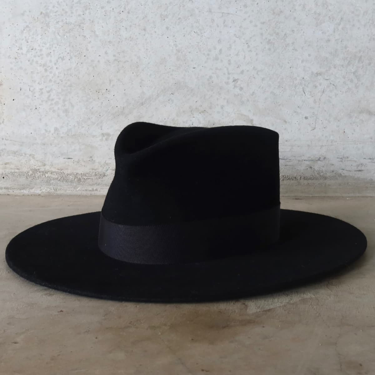 Front left angle of the black felt hat Core Black by PHYLLi Designs with black Japanese grosgrain band.