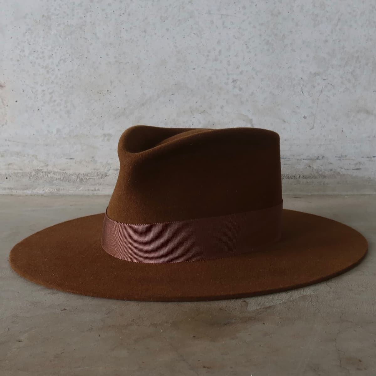 Front left angle of the caramel hat Core Caramel by PHYLLi Designs with chocolate Japanese grosgrain band.