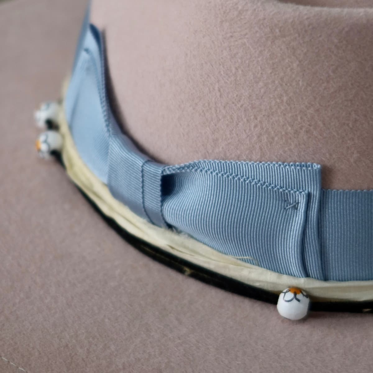 Close up detail of the Daisy felt hat showing cornflower Japanese grosgrain double bow band.