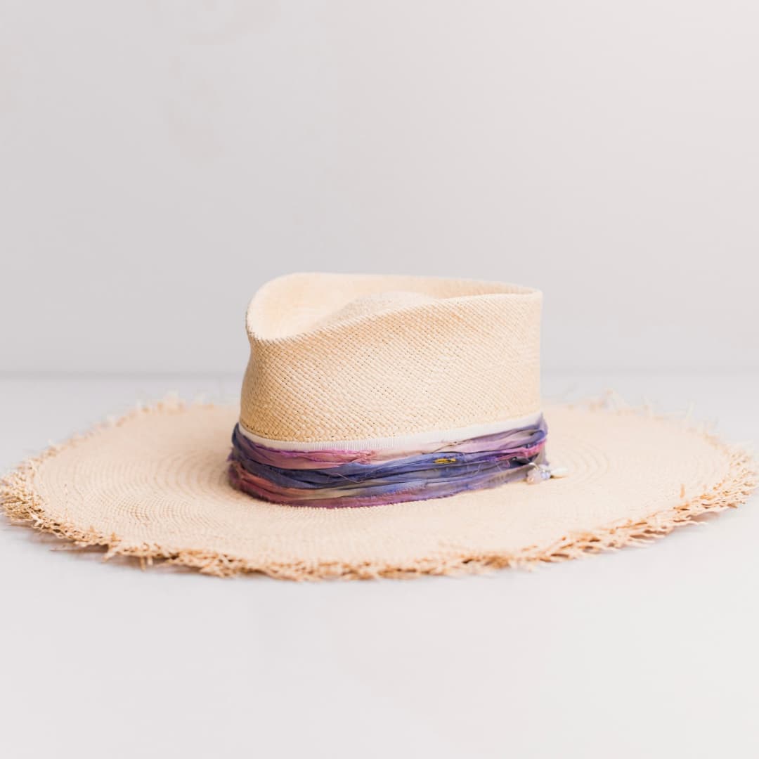 Front left angle of the natural Panama straw hat Delfina by PHYLLi Designs with ivory Japanese grosgrain band and sari silk trimming.