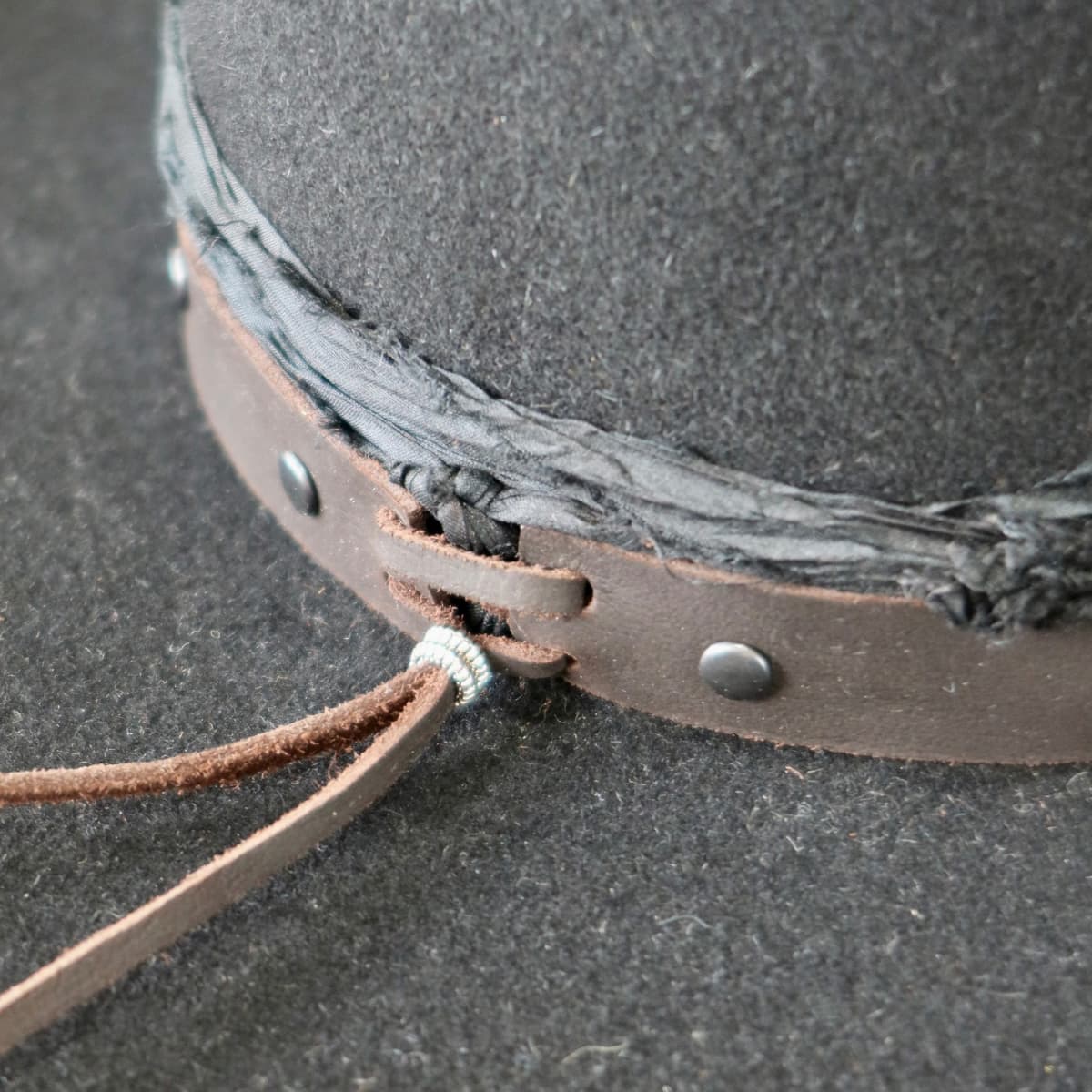 Close up detail of the Edwards felt cowboy hat showing buffalo leather tieback detail with bead.