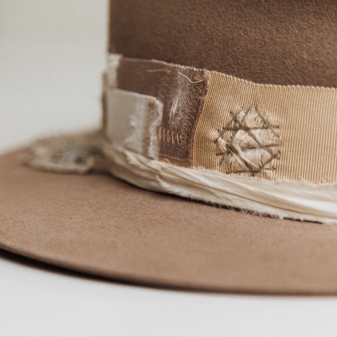 Close up detail of the Enso felt hat showing distressed taupe grosgrain band with visible hand stitching.