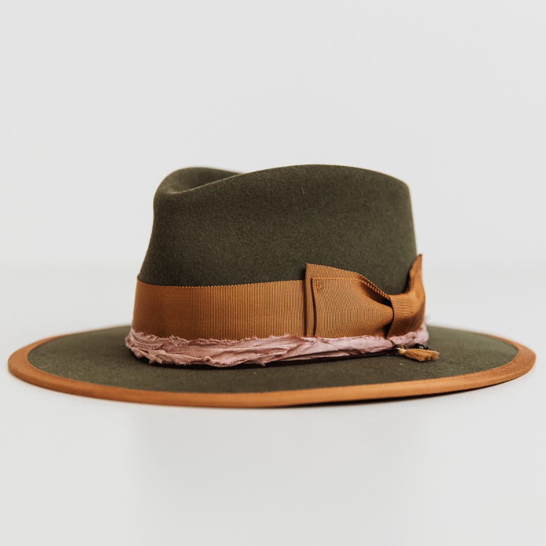 Front left angle of the Feuille Morte Military felt hat by PHYLLi Designs featuring copper double bow band and suede string.