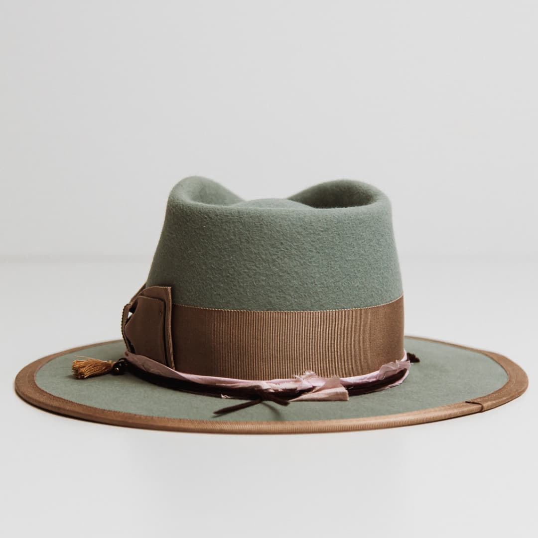 Back view of Feuille Morte Sage felt hat with taupe grosgrain band and chocolate suede string.