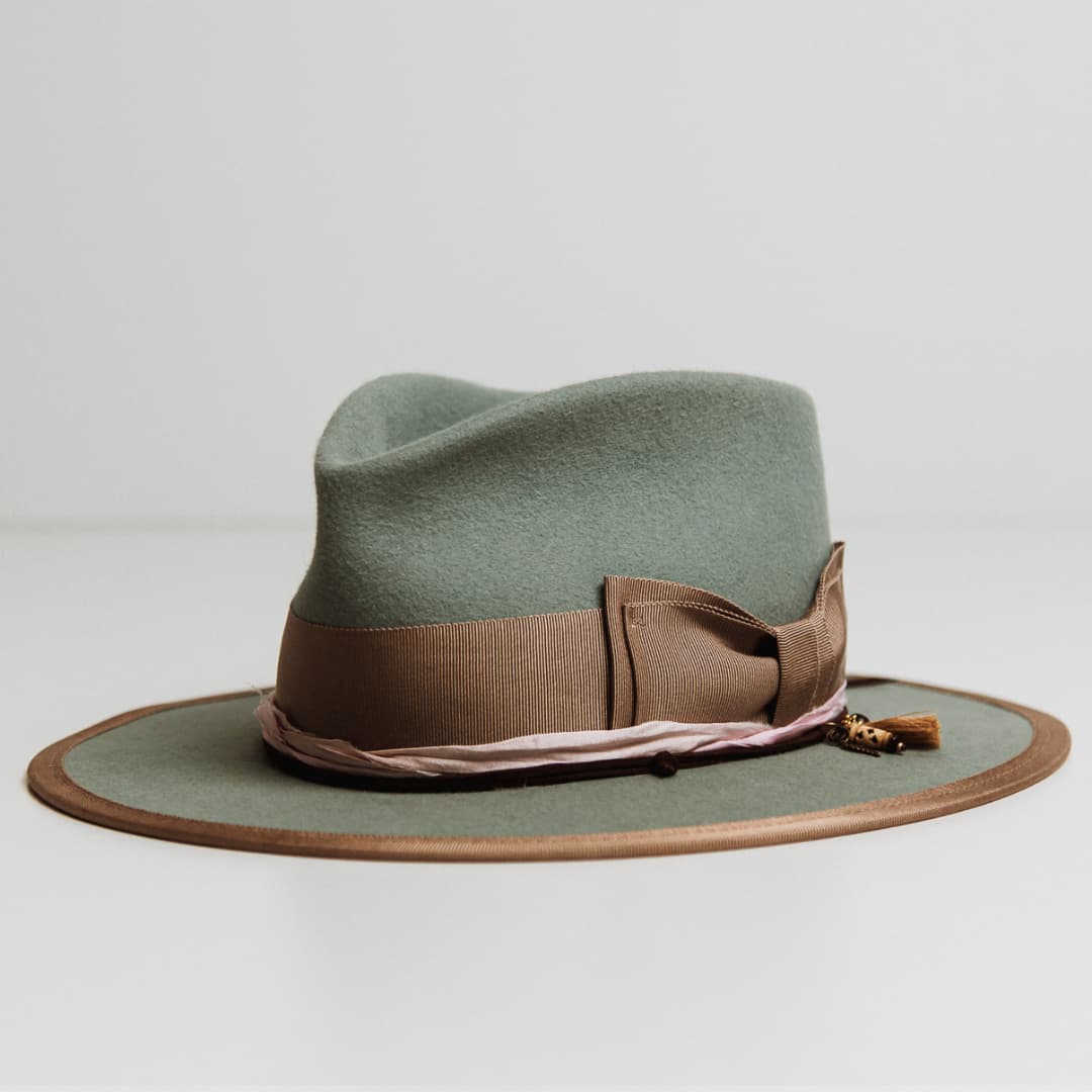 Feuille Morte Sage felt hat showing taupe grosgrain double bow band and charm cluster with tassel and charms.