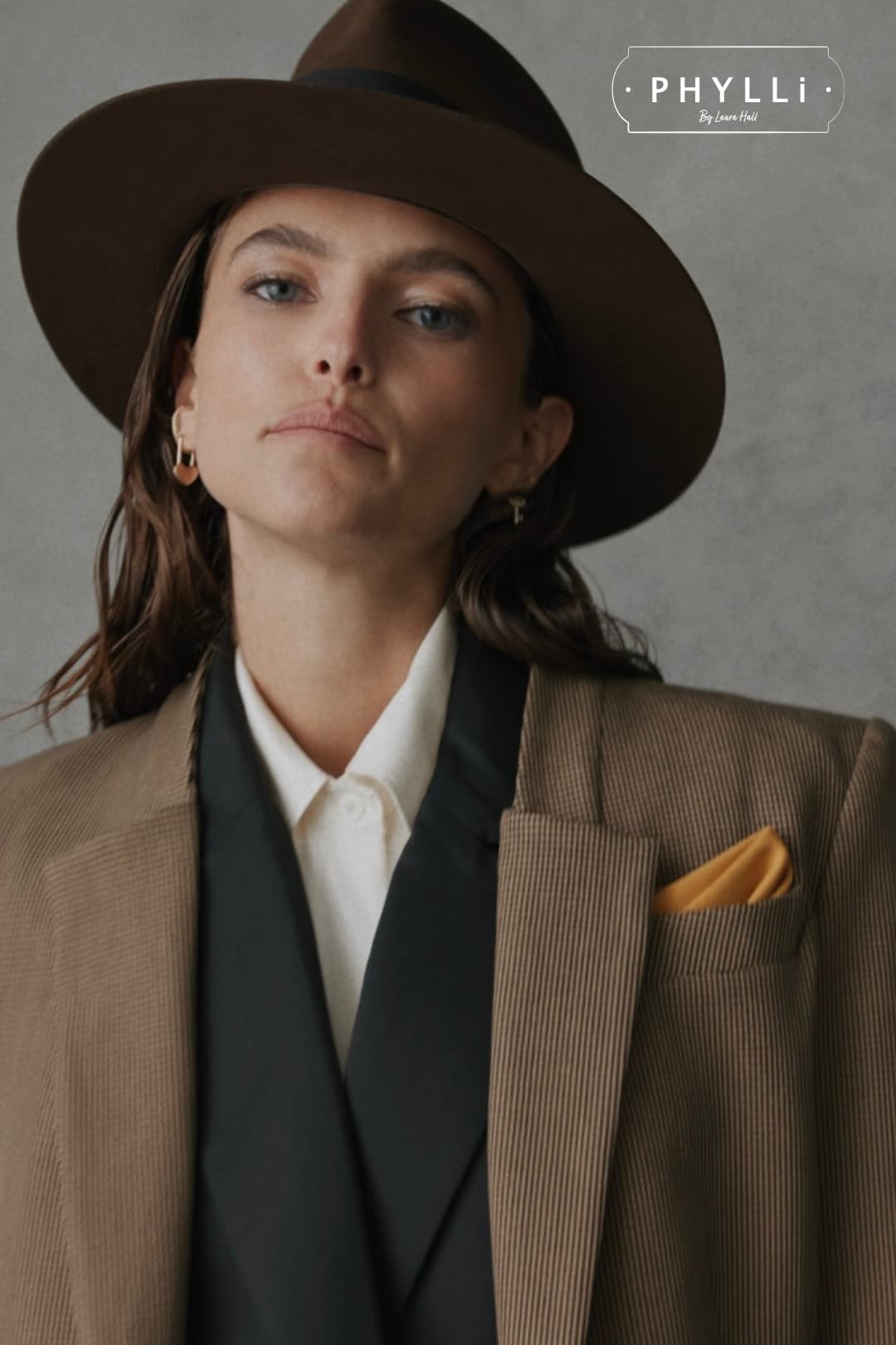 Close up woman wearing the Ghana chocolate felt hat by PHYLLi Designs with distressed black grosgrain bow band.