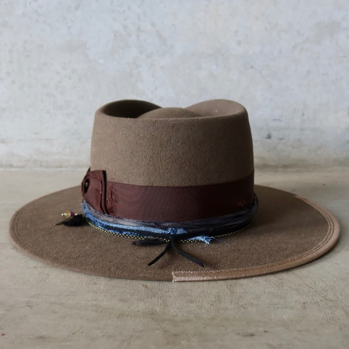 Back view of the Dirty Olive felt hat Grove by PHYLLi Designs featuring taupe Japanese grosgrain brim trim and double brim stitch in chocolate.