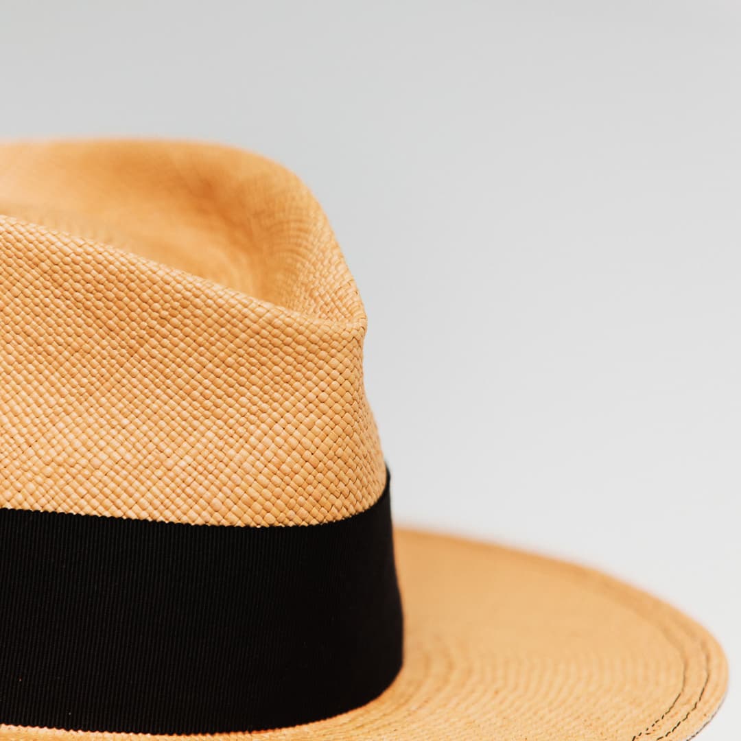 Detail of Holiday Biscuit Panama hat showing Black double brim stitch.