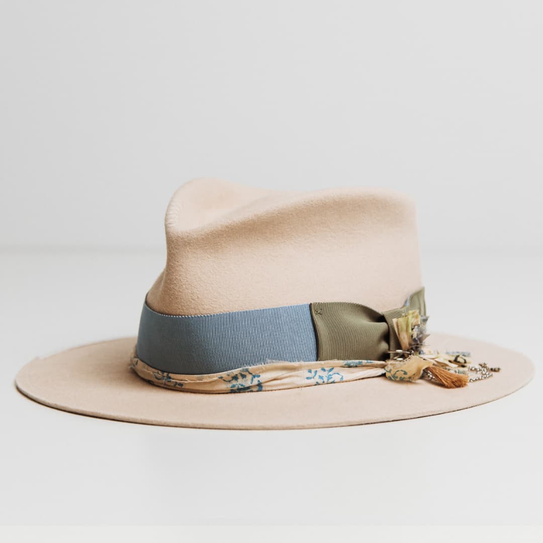 Front left angle of the Hunter beige felt hat by PHYLLi Designs with cornflower japanese grosgrain band, oil green bow and sari silk trim.