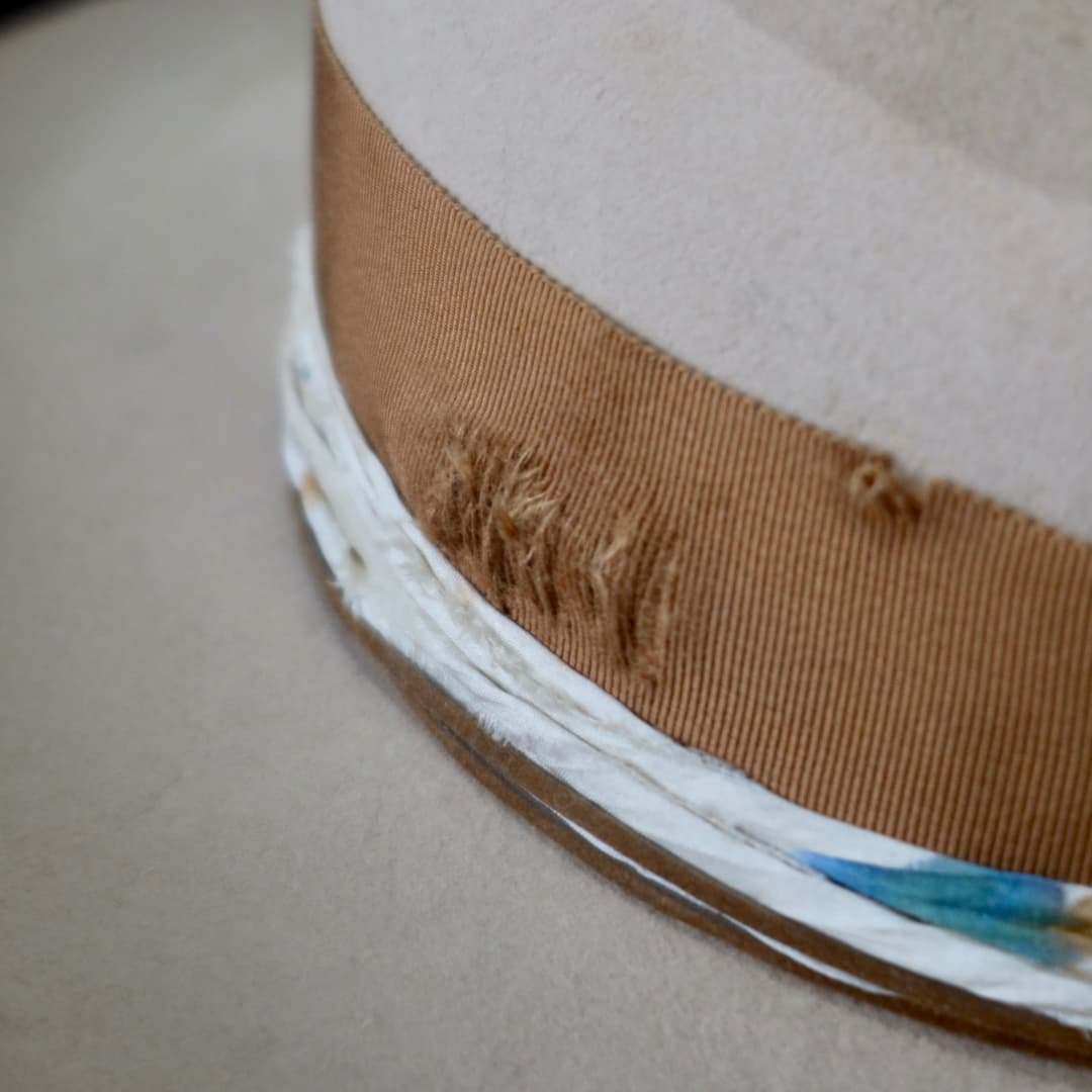 Close up detail of the Iluka cowboy hat showing the distressed copper grosgrain band and speckled sari silk trim.
