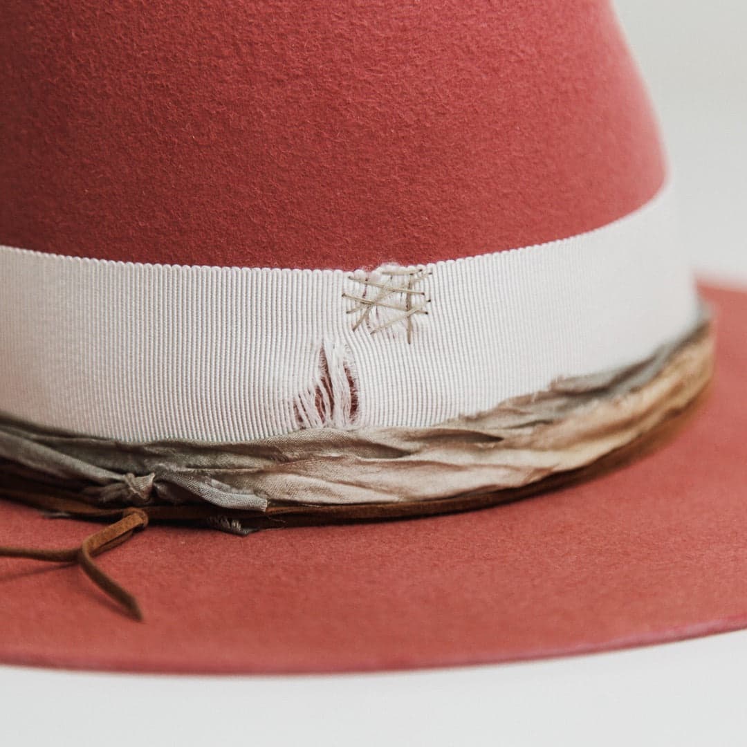 Close up detail of the Kentucky felt hat showing distressed ivory grosgrain band with stone stitched repair and sari silk trimming.