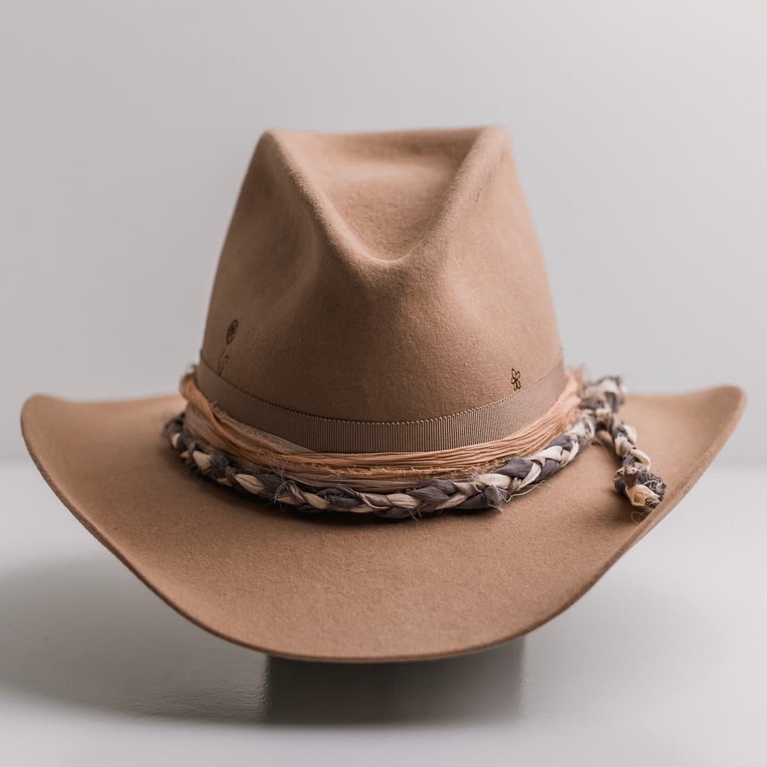 Camel felt cowboy hat La Fleurs by PHYLLi Designs with taupe Japanese grosgrain band and braided sari silk trim in Storm, Ivory and Mushroom.