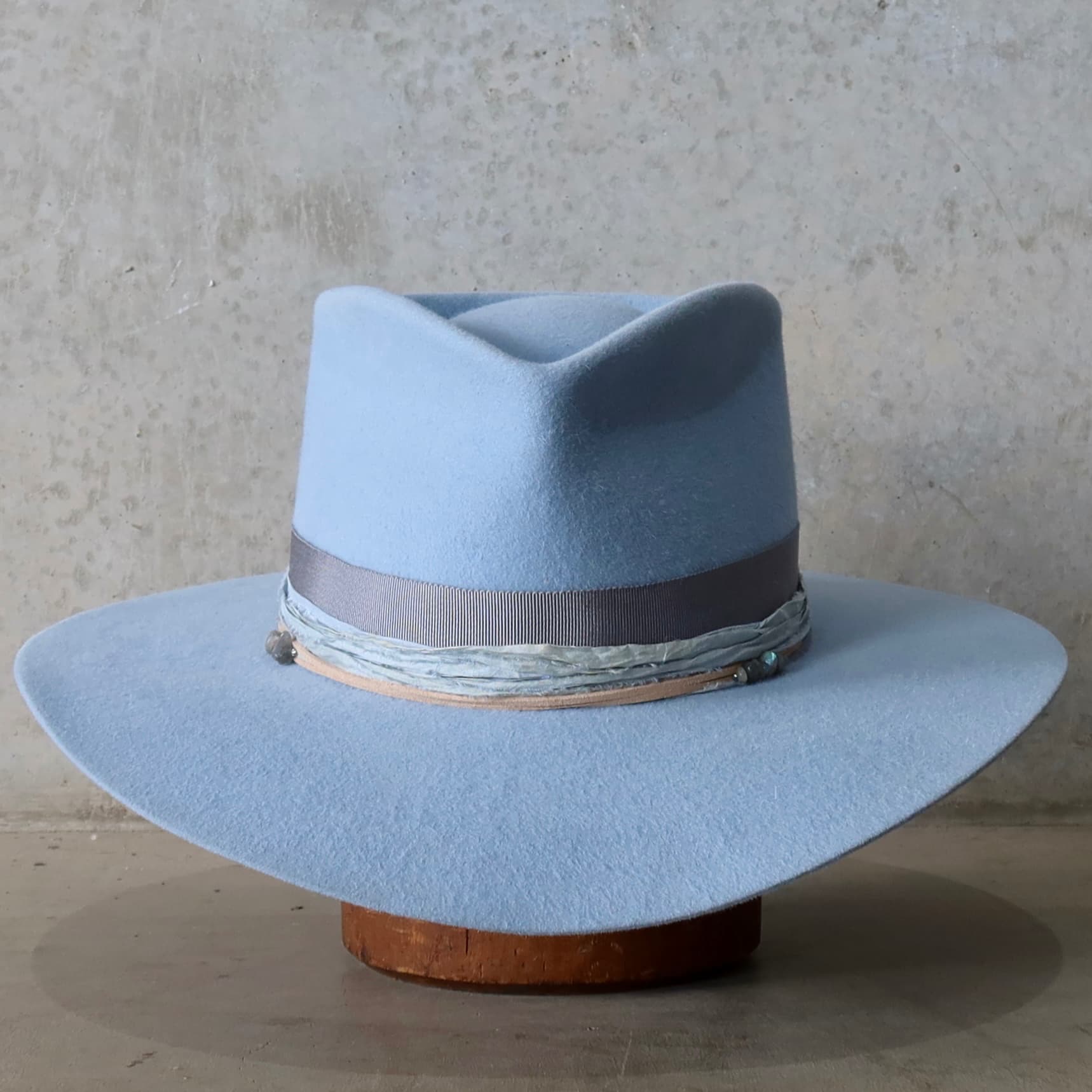 La Journee Crystal Blue felt hat by PHYLLi Designs with Japanese grosgrain band in Cement and storm sari silk trim.