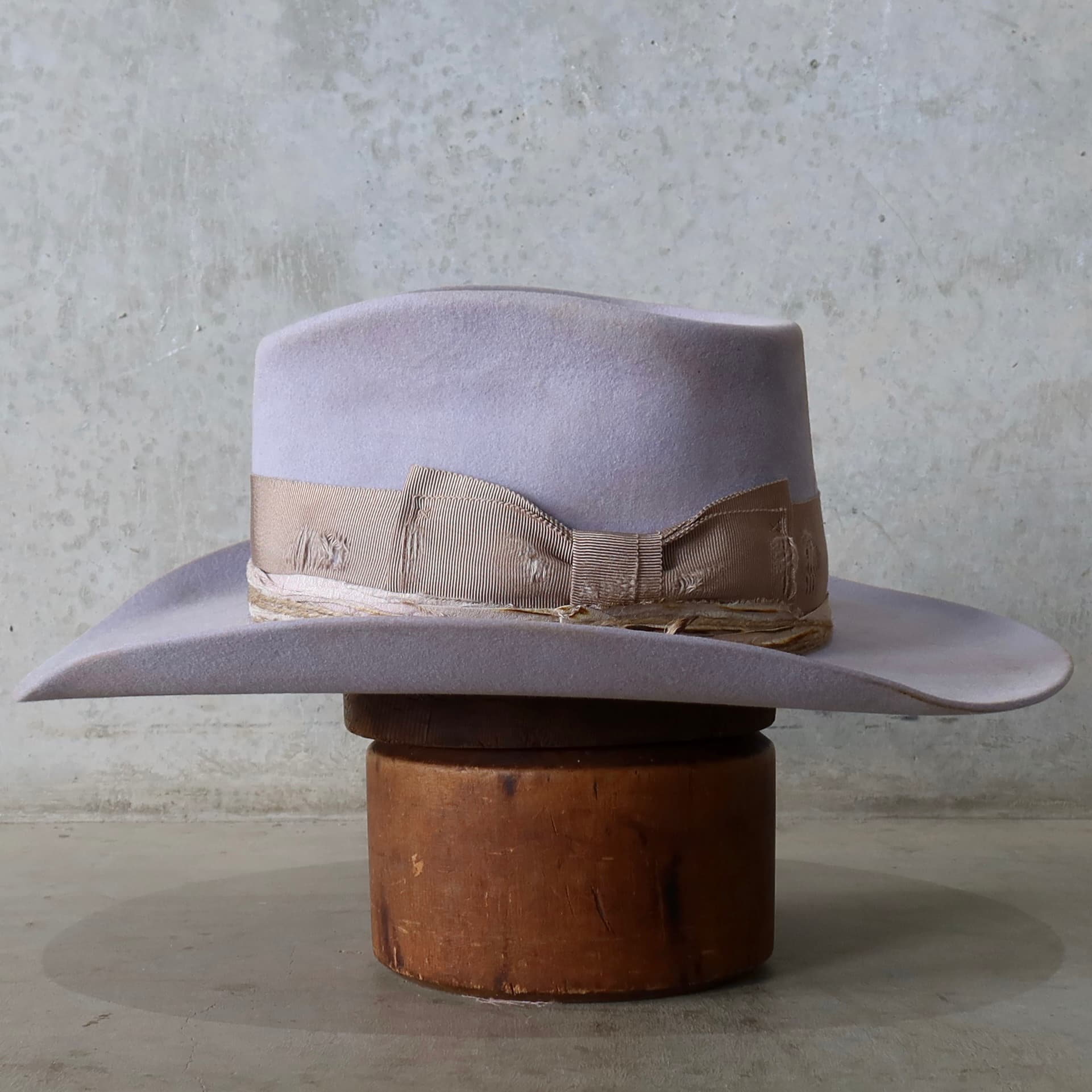 Left side view of the lilac distressed felt cowgirl hat Lacey by PHYLLi Designs with sari silk trim and twine wraps.