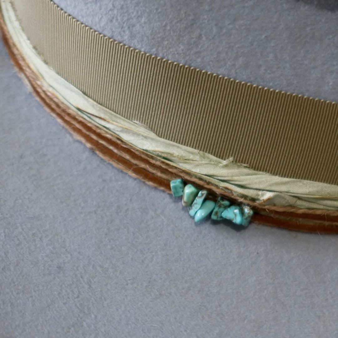 Close up detail of the Lagoon felt hat showing mint sari silk trim beneath the oil green grosgrain band.