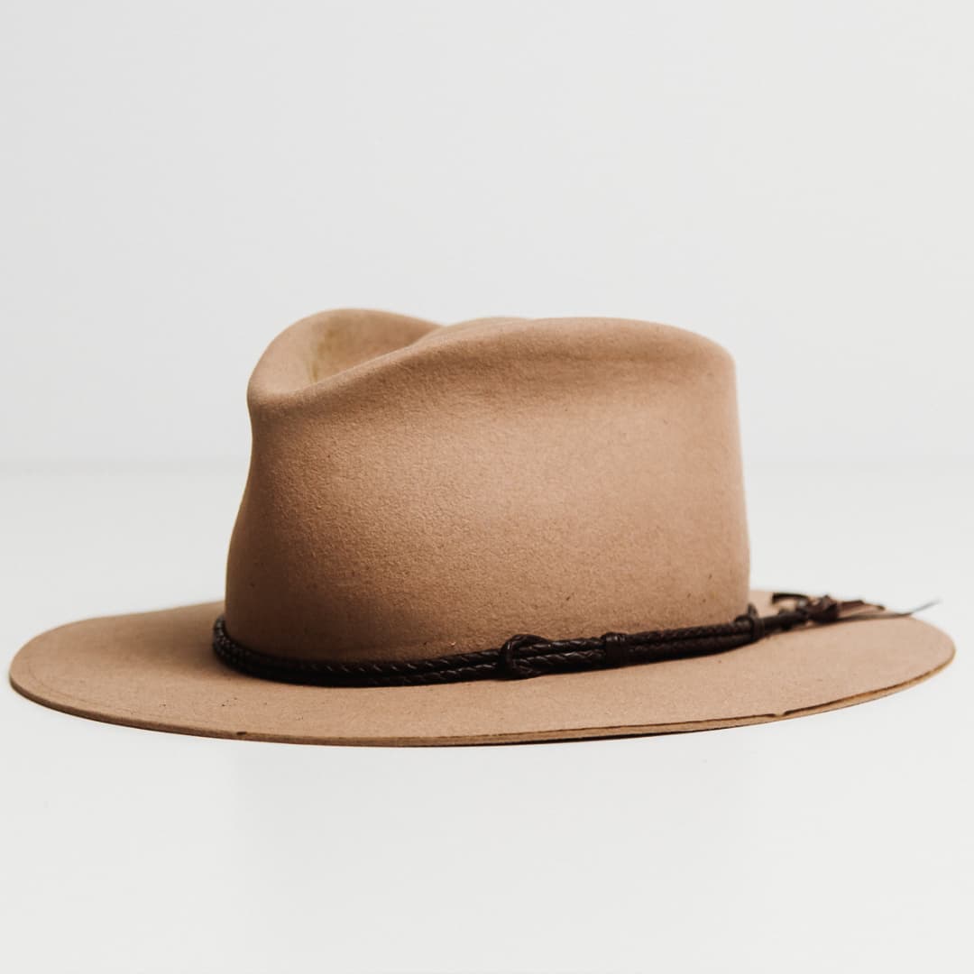 Front left angle of the Laurie Hat Band featuring hand plaited dark brown kangaroo hide on a Sahara felt hat by PHYLLi Designs.