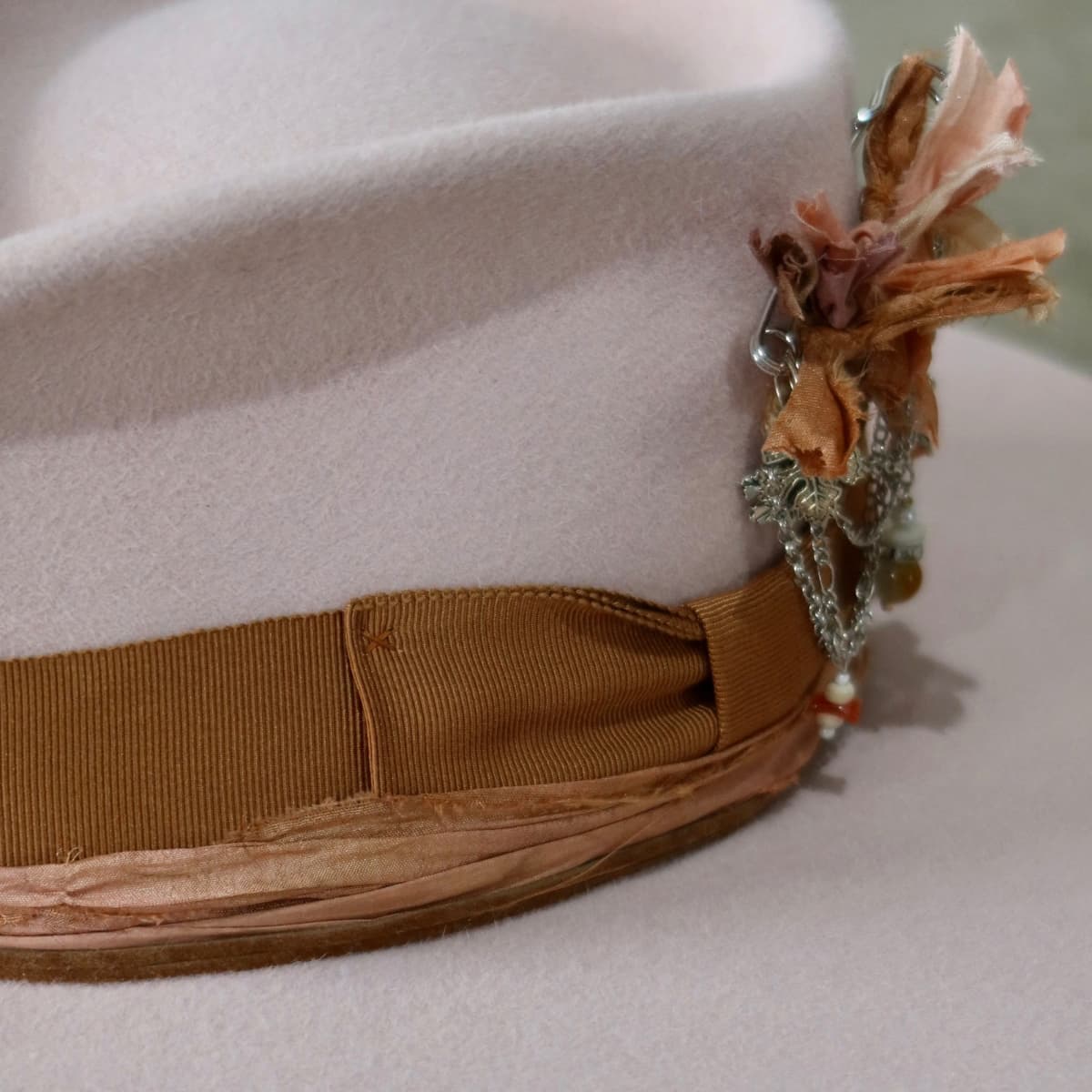 Close up detail of the Lexie felt hat showing copper Japanese grosgrain bow band.