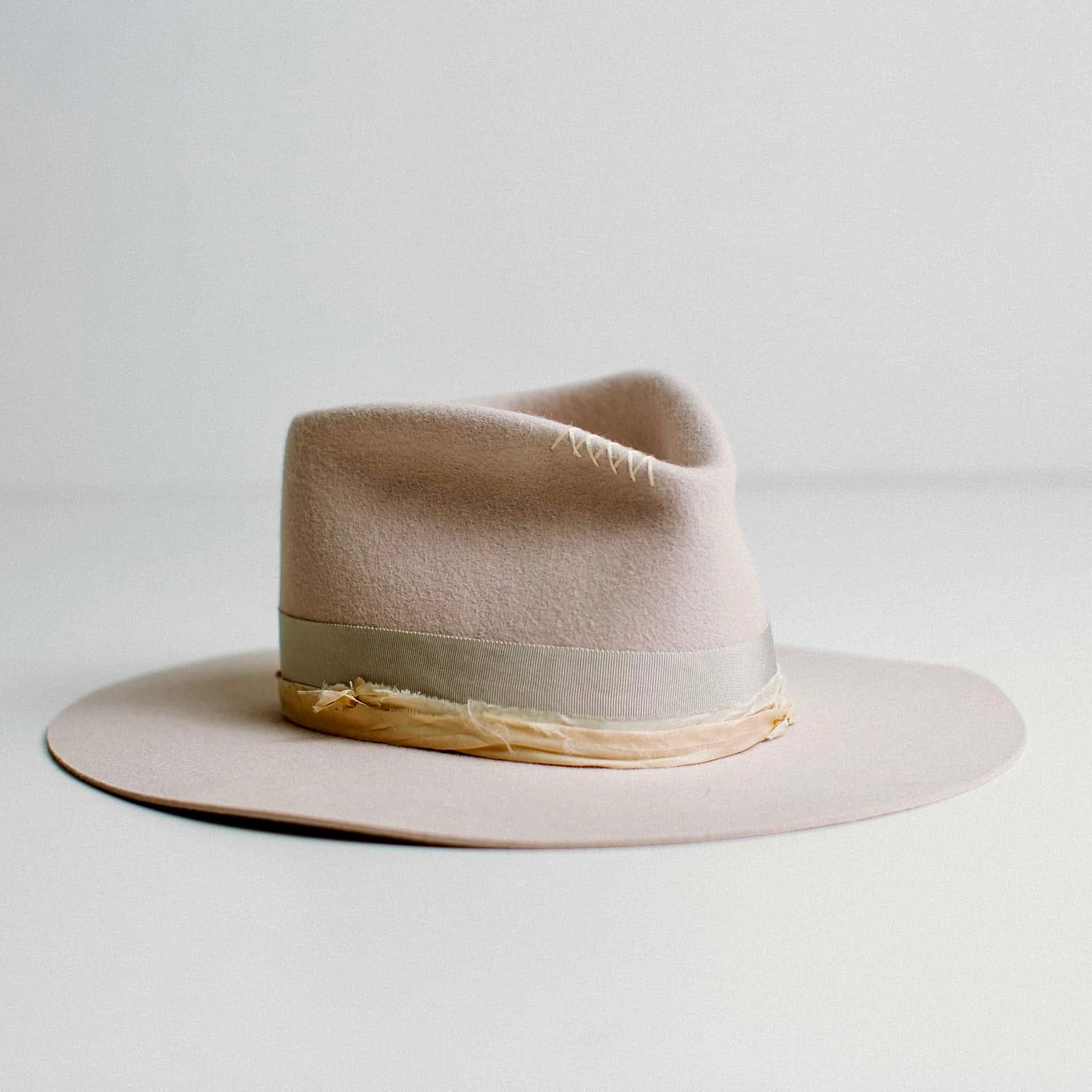 Front right angled view of Lilac Fields light lilac felt hat showing ivory hand-stitched cross detail by PHYLLi Designs.