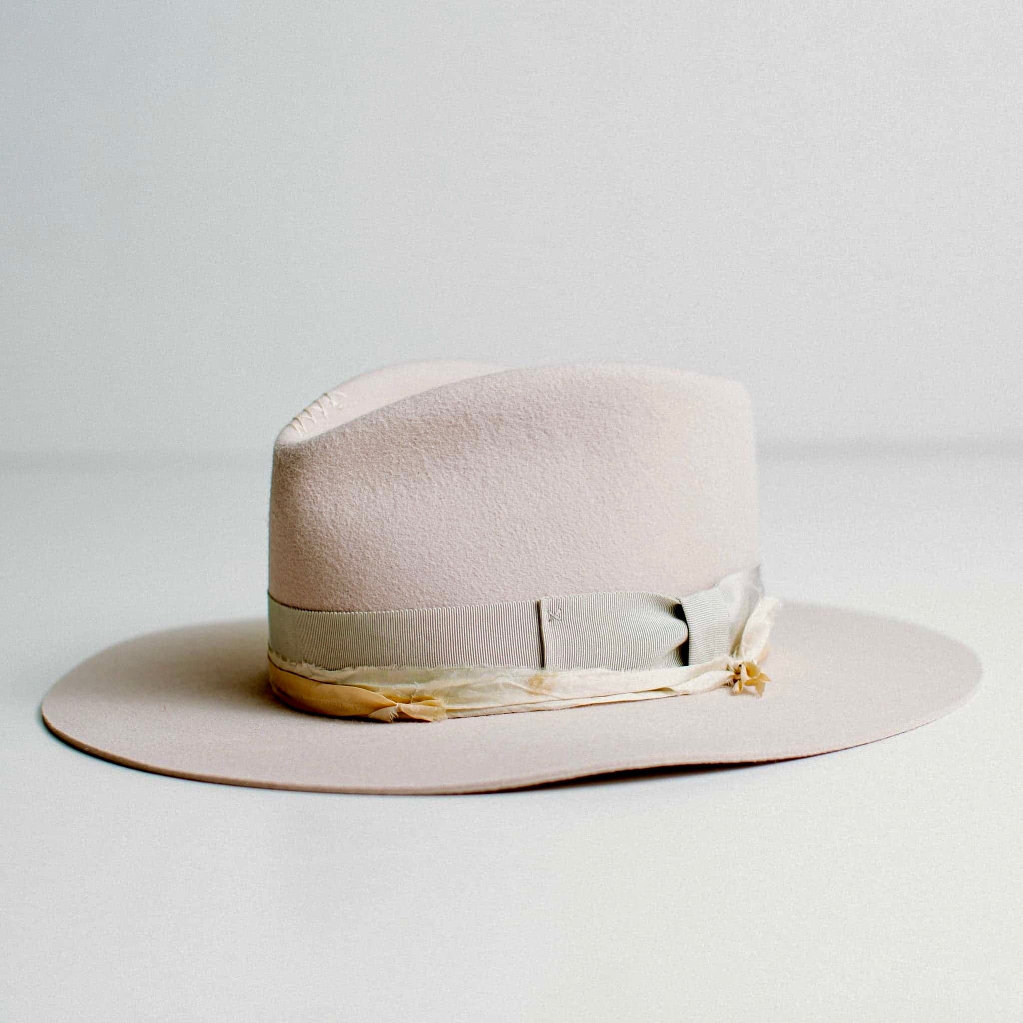 Front left angled view of Lilac Fields light lilac felt hat with vintage grosgrain bow band and sari silk trim.