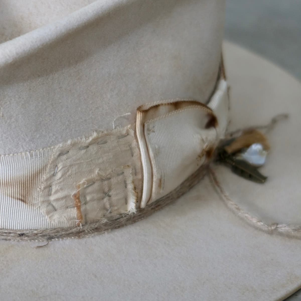 Close up detail of the Lucille Limited Edition felt hat showing hand-stitched patchwork trims in cotton and silk.