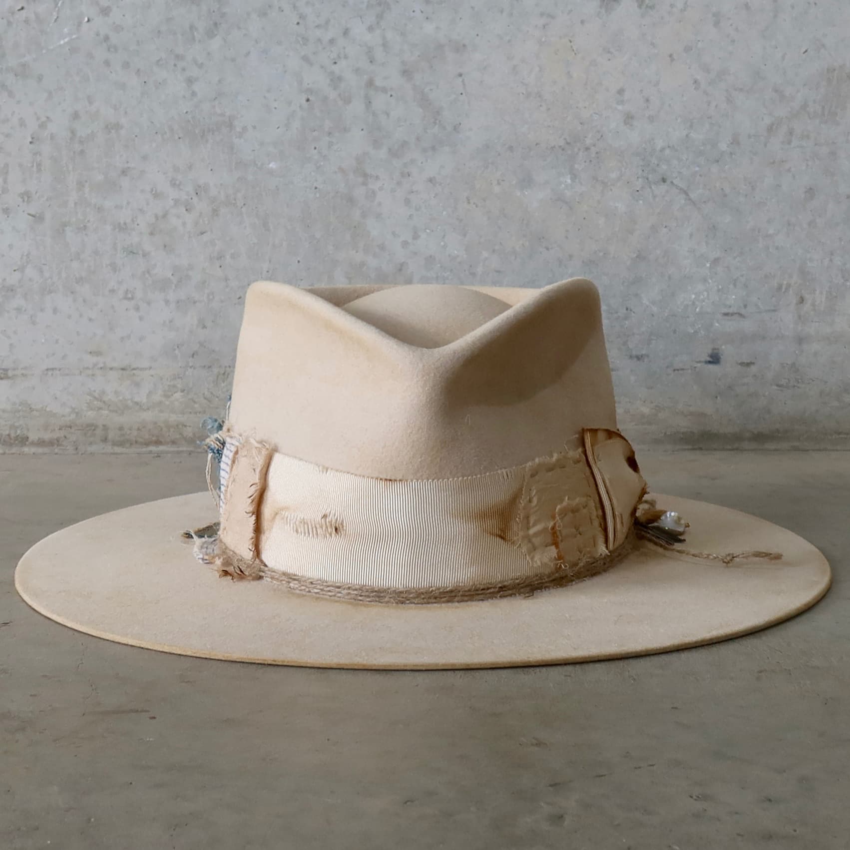 Beige felt hat Lucille Limited Edition by PHYLLi Designs with distressed ivory Japanese grosgrain double bow band and charm cluster.