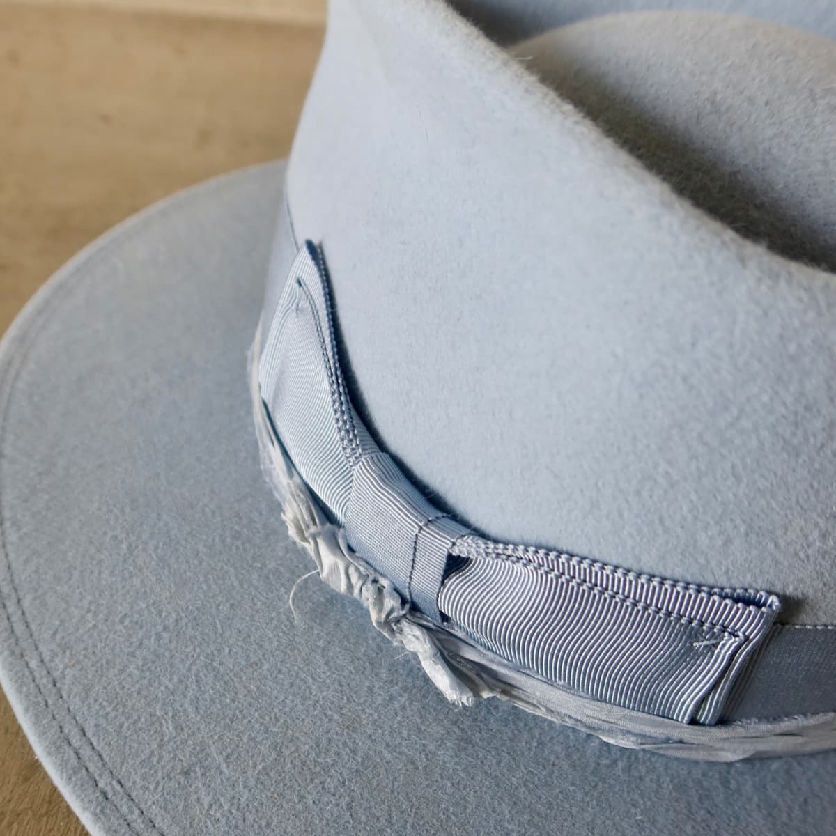 Close up detail of the Lucinda felt hat showing cornflower Japanese grosgrain double bow band.