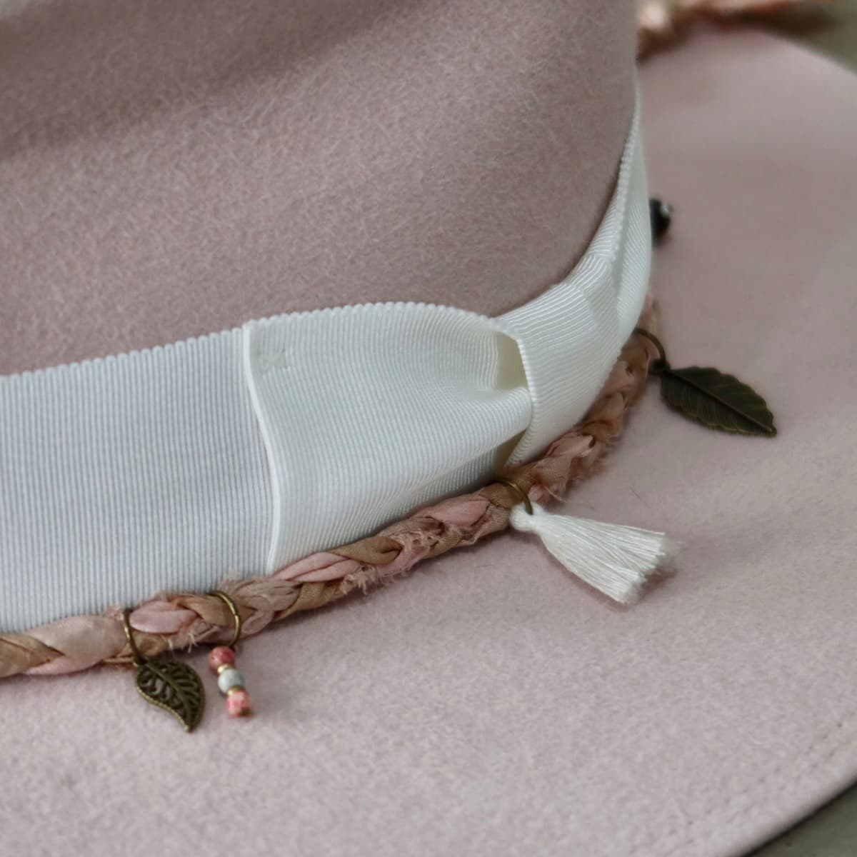 Close up detail of the Lucky Charm felt hat showing ivory Japanese grosgrain bow band and Charm Plait.