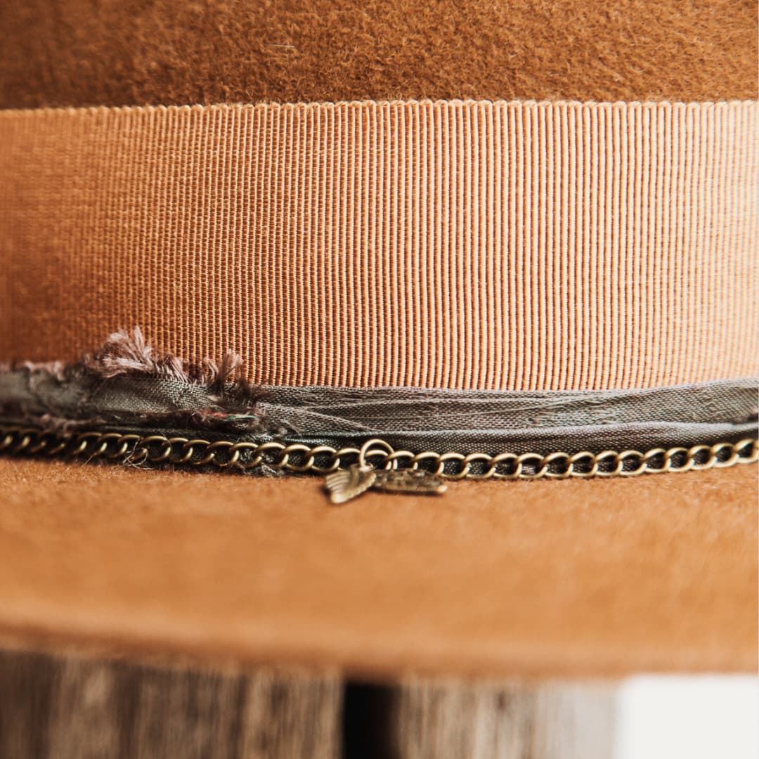 Close up detail of the Maple felt hat showing copper Japanese grosgrain band with sari silk trimming and bronze crown chain.