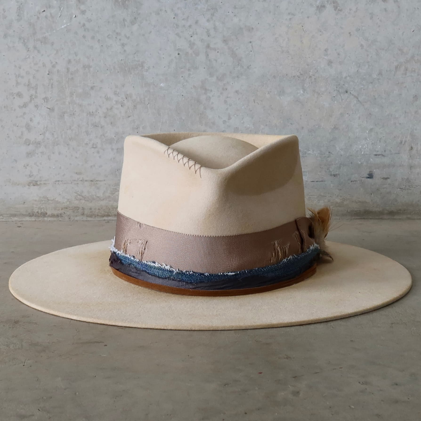 Beige distressed felt hat McVeigh by PHYLLi Designs with navy sari silk and denim trimming.