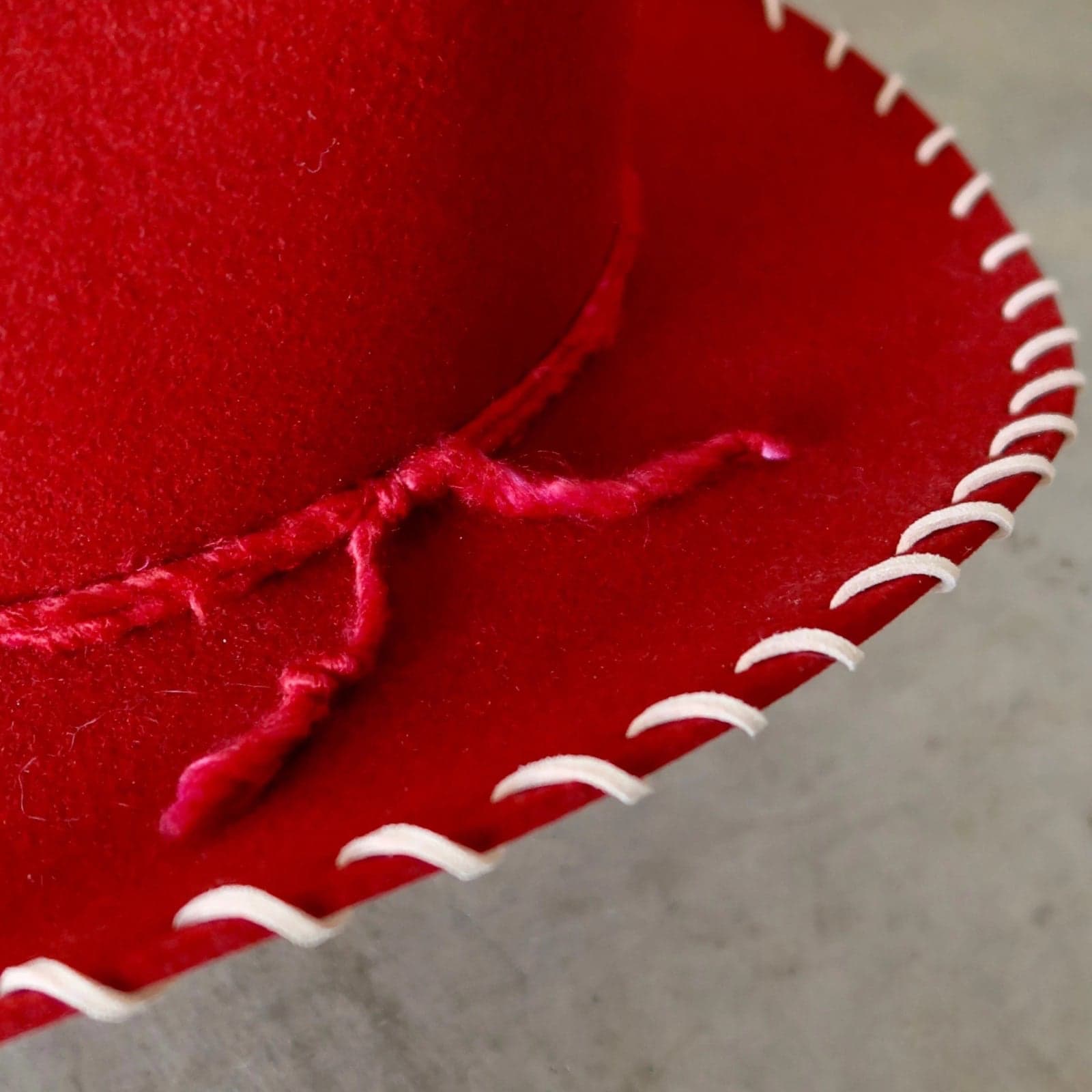 Close up detail of the Nevada cowboy hat showing tonal red silk yarn wraps around the crown.