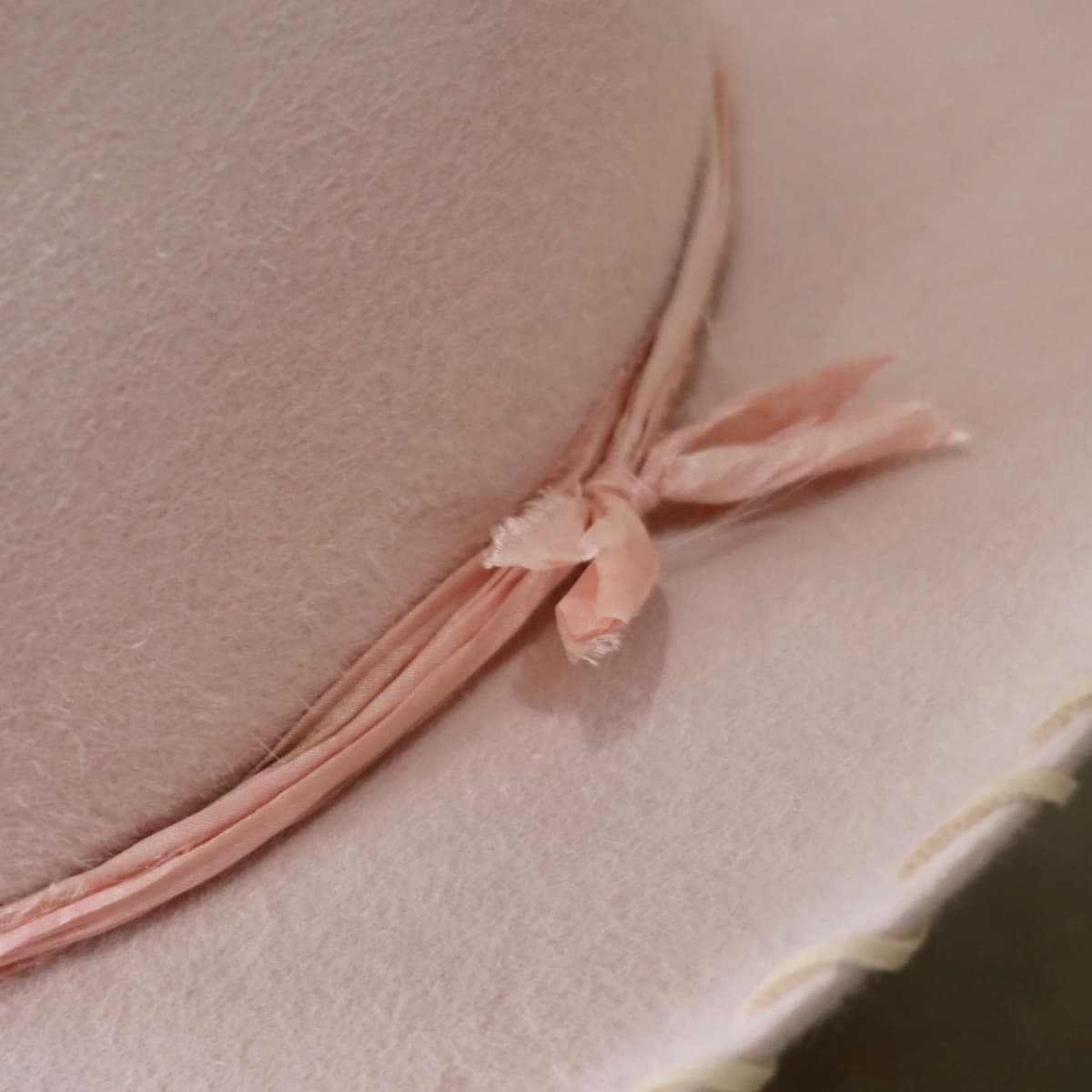 Close up detail of the Nevada cowboy hat showing tonal pink silk yarn wraps tied around the crown.