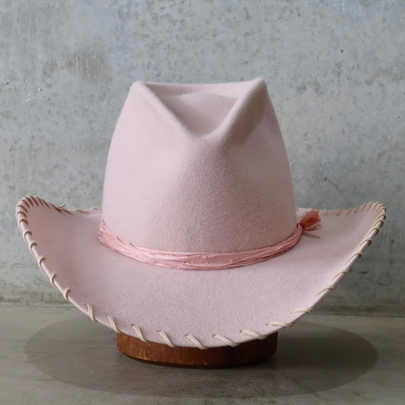 Baby pink cowboy hat Nevada by PHYLLi Designs with tonal silk yarn wraps.