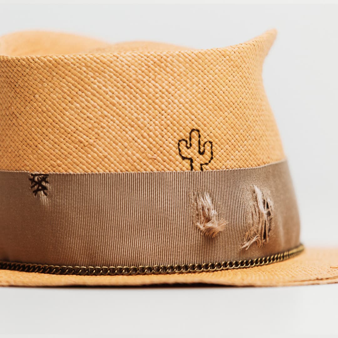 Detail of Normie Panama showing burnt branded cactus on biscuit toquilla straw.
