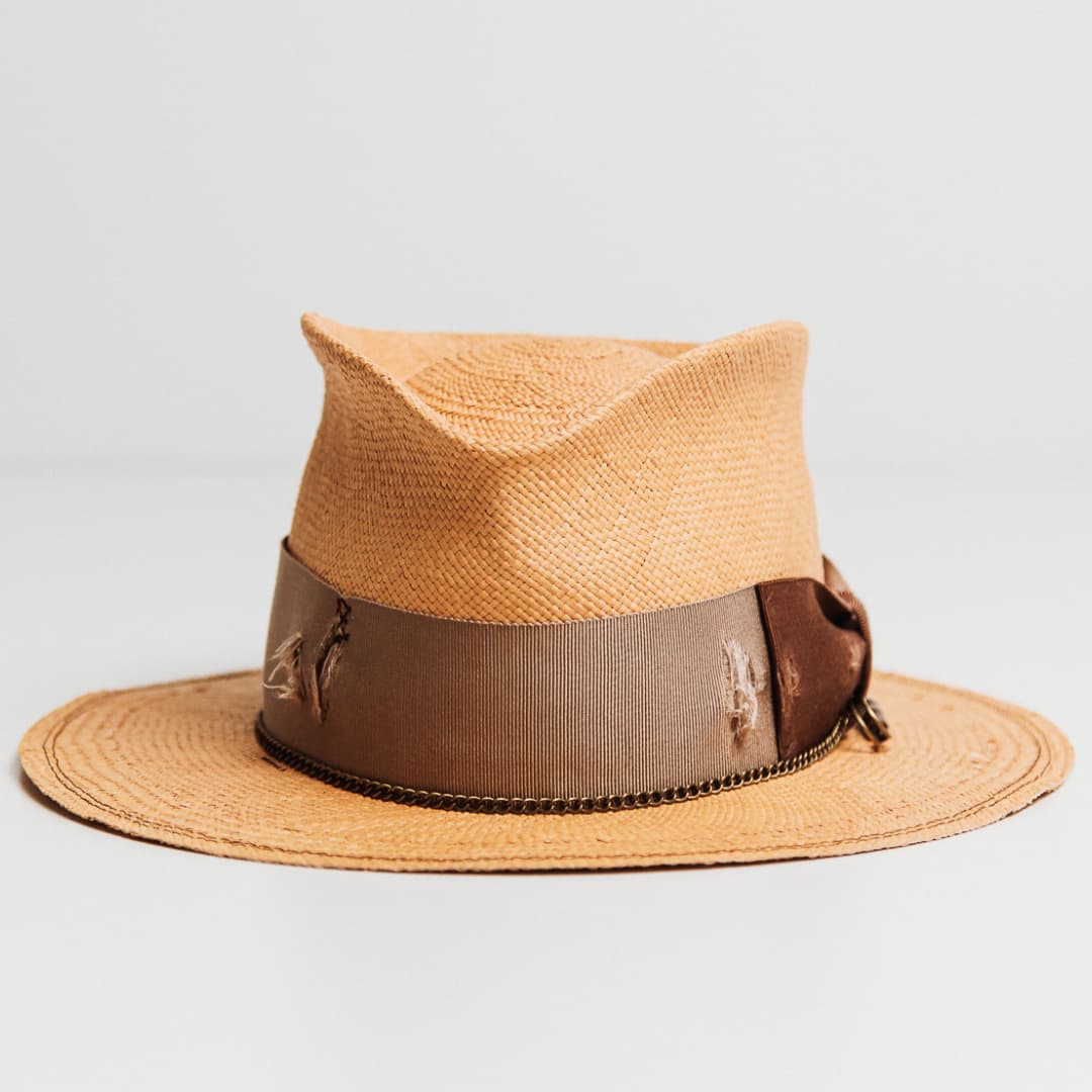 Normie Panama hat in Biscuit with distressed Taupe grosgrain band, Chocolate bow and bronze crown chain.