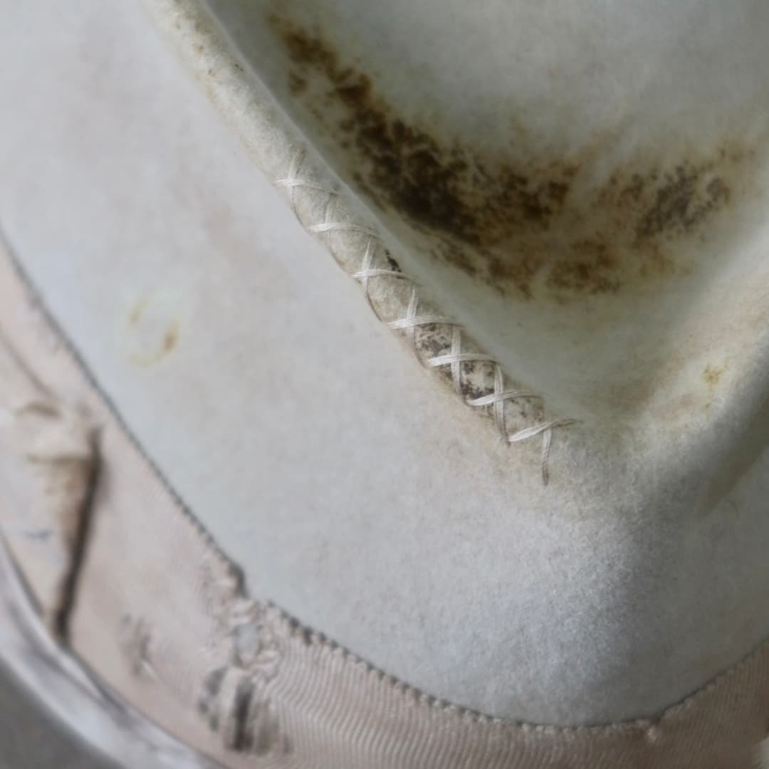 Detail
Close up detail of the Oakley Limited Edition felt hat showing hand-stitched cross detailing in taupe.