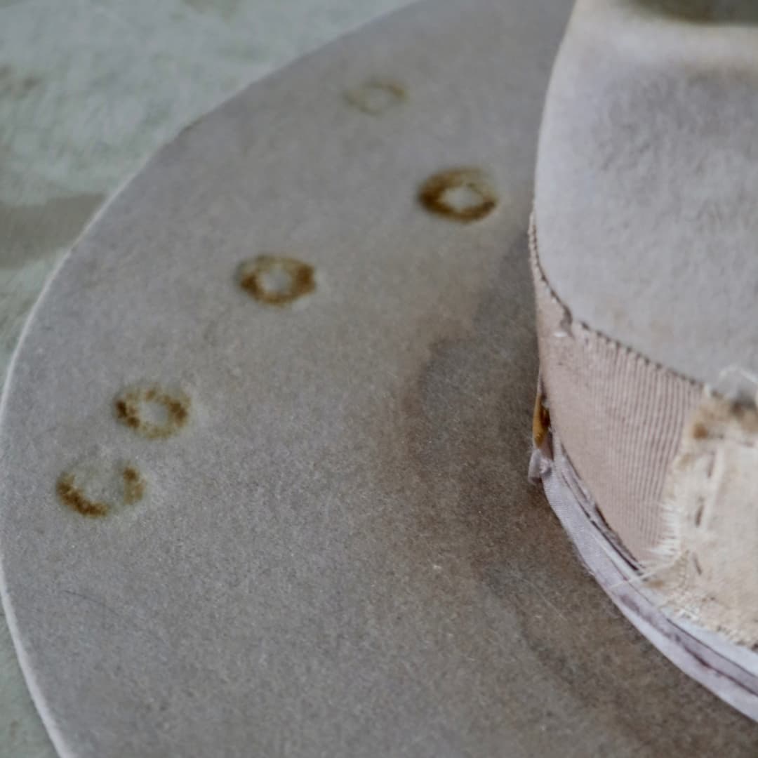 Close up detail of the Oakley Limited Edition felt hat showing distressed Sahara felt with vintage burn markings.