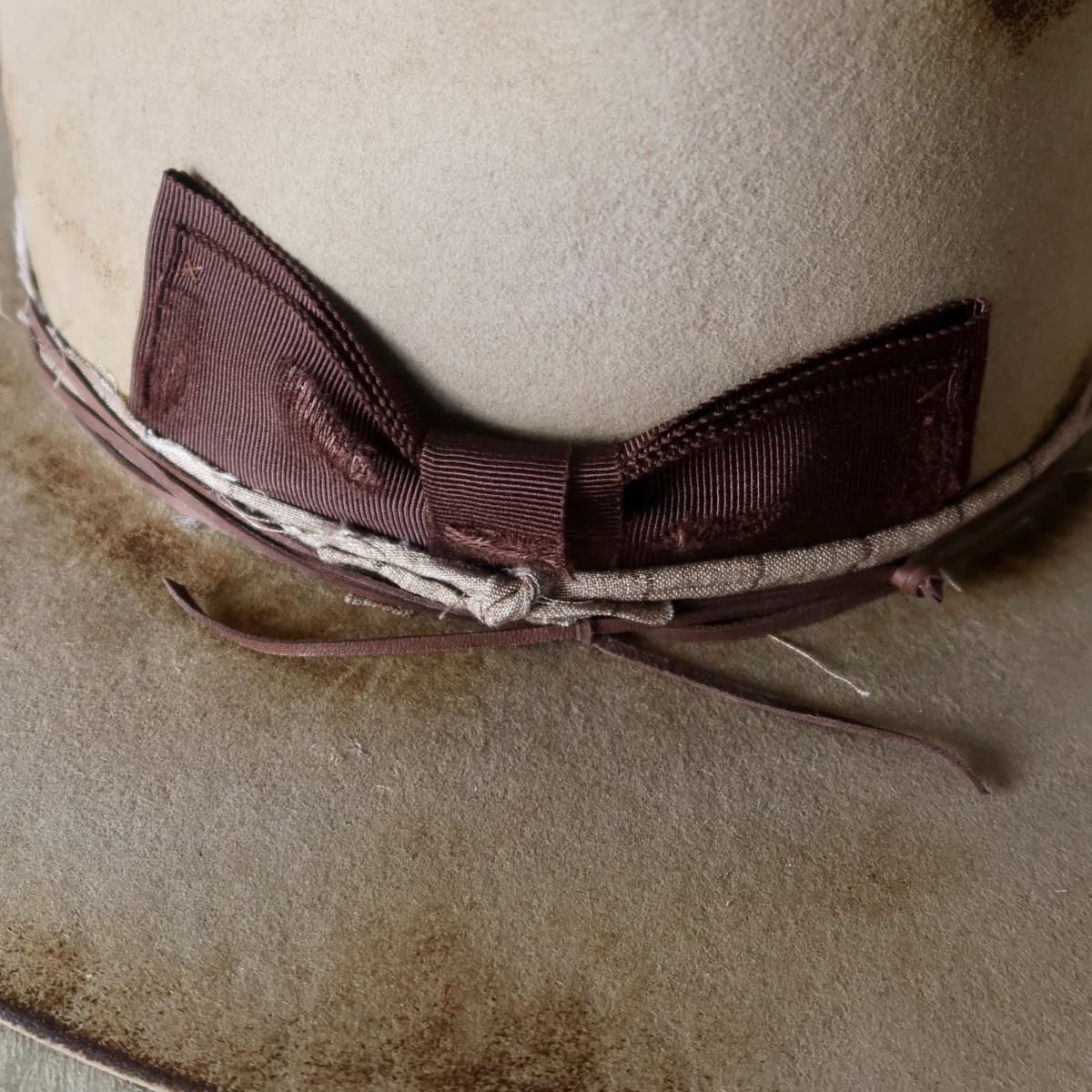 Close up detail of the Old Joe hat showing distressed dark brown Japanese grosgrain floating double bow.