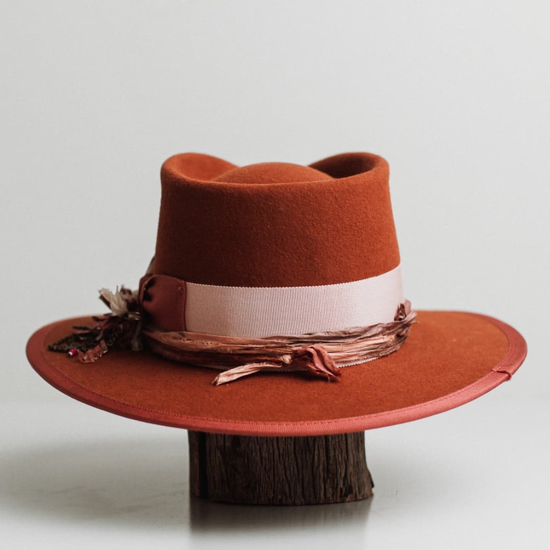 Back view of the Pamela spiced pumpkin felt hat by PHYLLi Designs featuring sherbet pink grosgrain band and watermelon brim trim.
