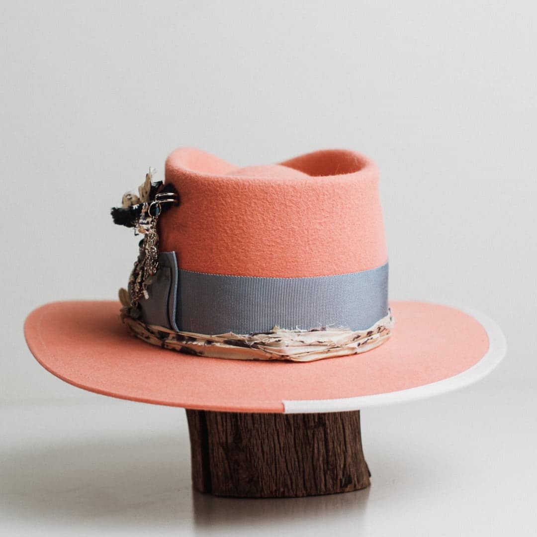 Back view of the Pāua peach felt hat by PHYLLi Designs featuring cornflower grosgrain band and sari silk trimming.
